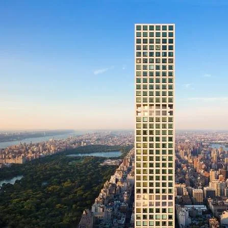 Tall skyscraper with a grid-like facade in New York City with Central Park and river in the background.