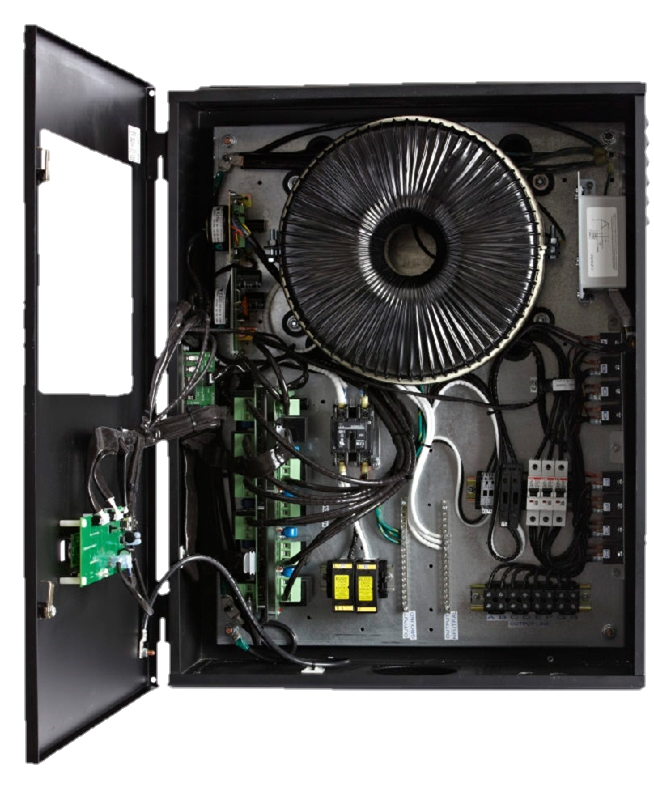 Inside view of an electrical panel with various wires, circuit breakers, and a large coil transformer.