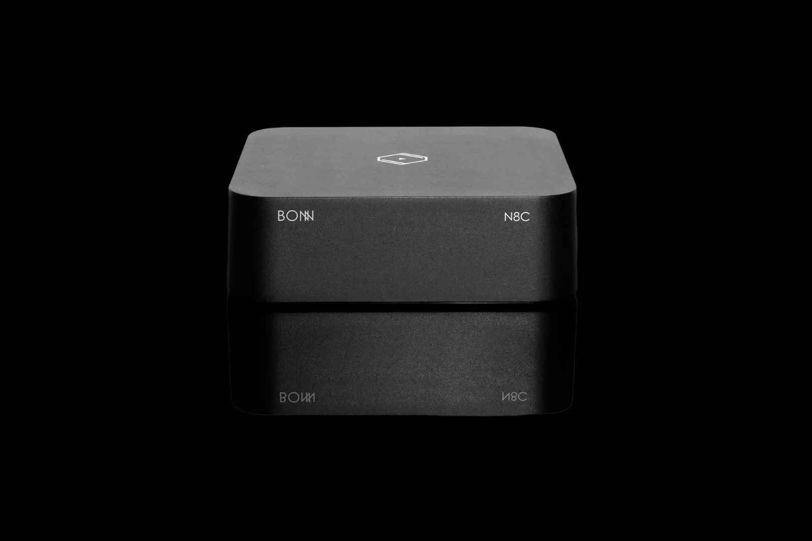 A black, cube-shaped electronic device with a matte finish, displaying the words 'BOWN' and 'N8C' on its front face, set against a dark background.