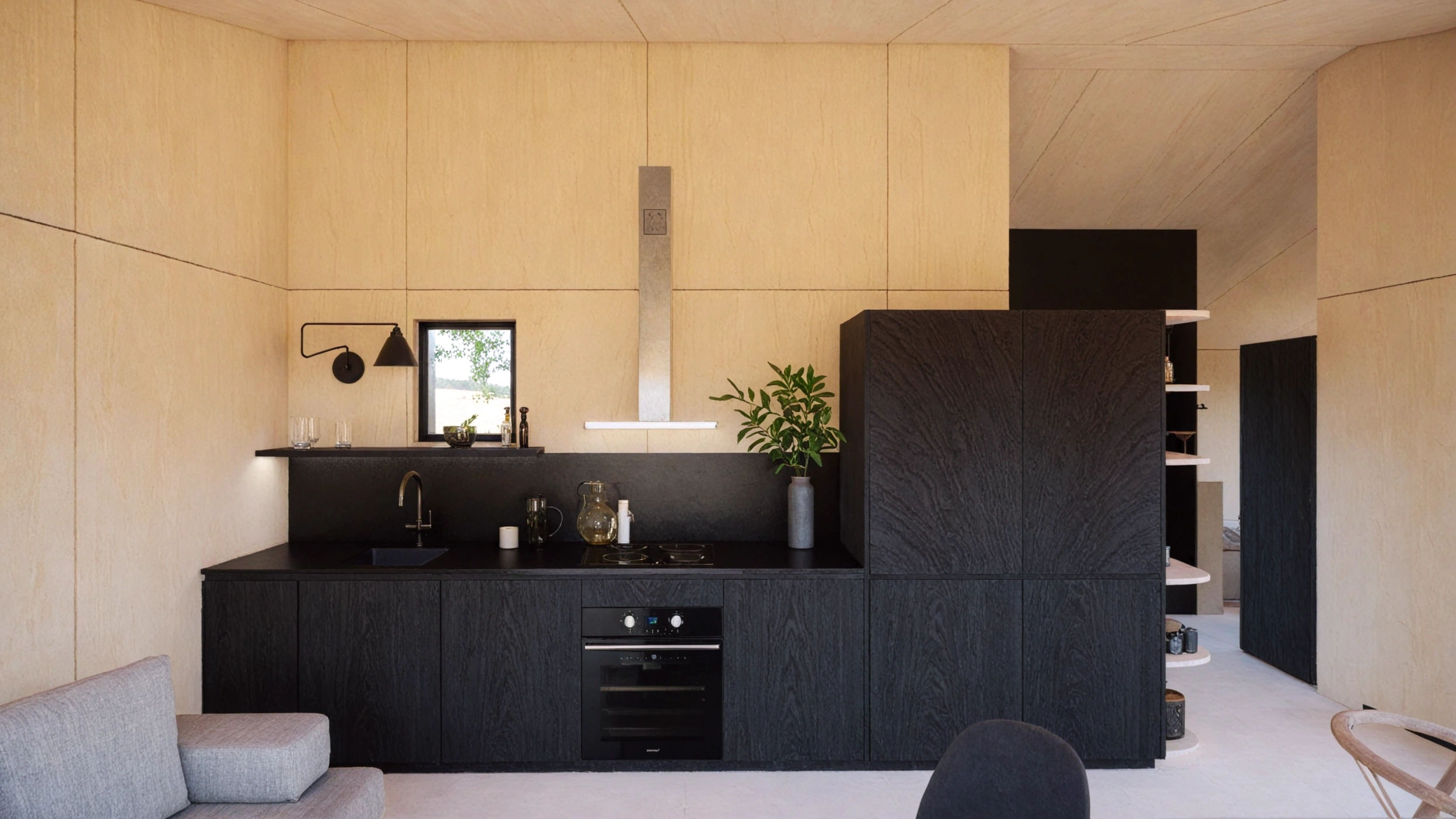 Interior de una cabaña moderna de madera en un entorno natural, cocina moderna y minimalista en tonos negros. Ubicada en León, España. Diseñada por MOR Studio