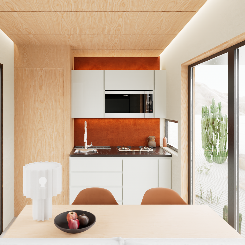 Interior de cabina de hotel móvil. Zona de cocineta y mesa para comer. Madera clara, tonos blancos y anaranjados que se funden con los colores del exterior. Para ubicar en Baja California y disfrutar de la naturaleza. Diseñada por MOR Studio.