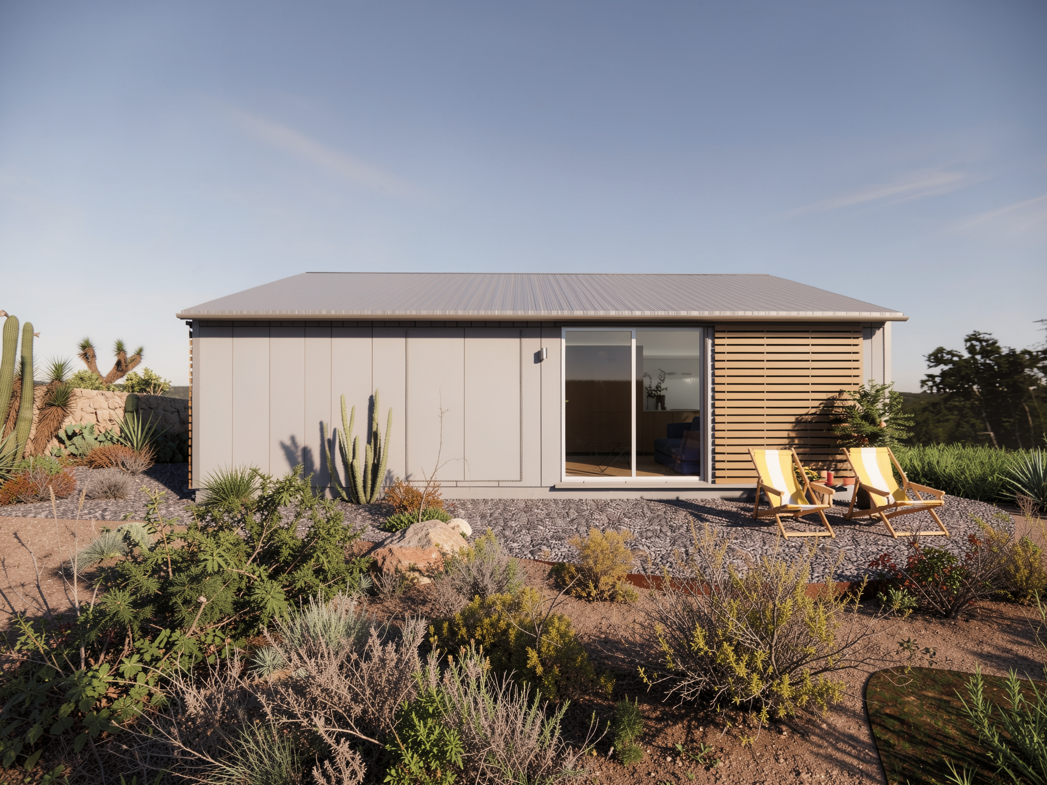 Segunda residencia compacta y prefabricada, con un amplio ventanal que conecta con una terraza exterior, la fachada es de paneles de concreto prefabricados, ubicada en un entorno natural en San Miguel de Allende, Mexico.