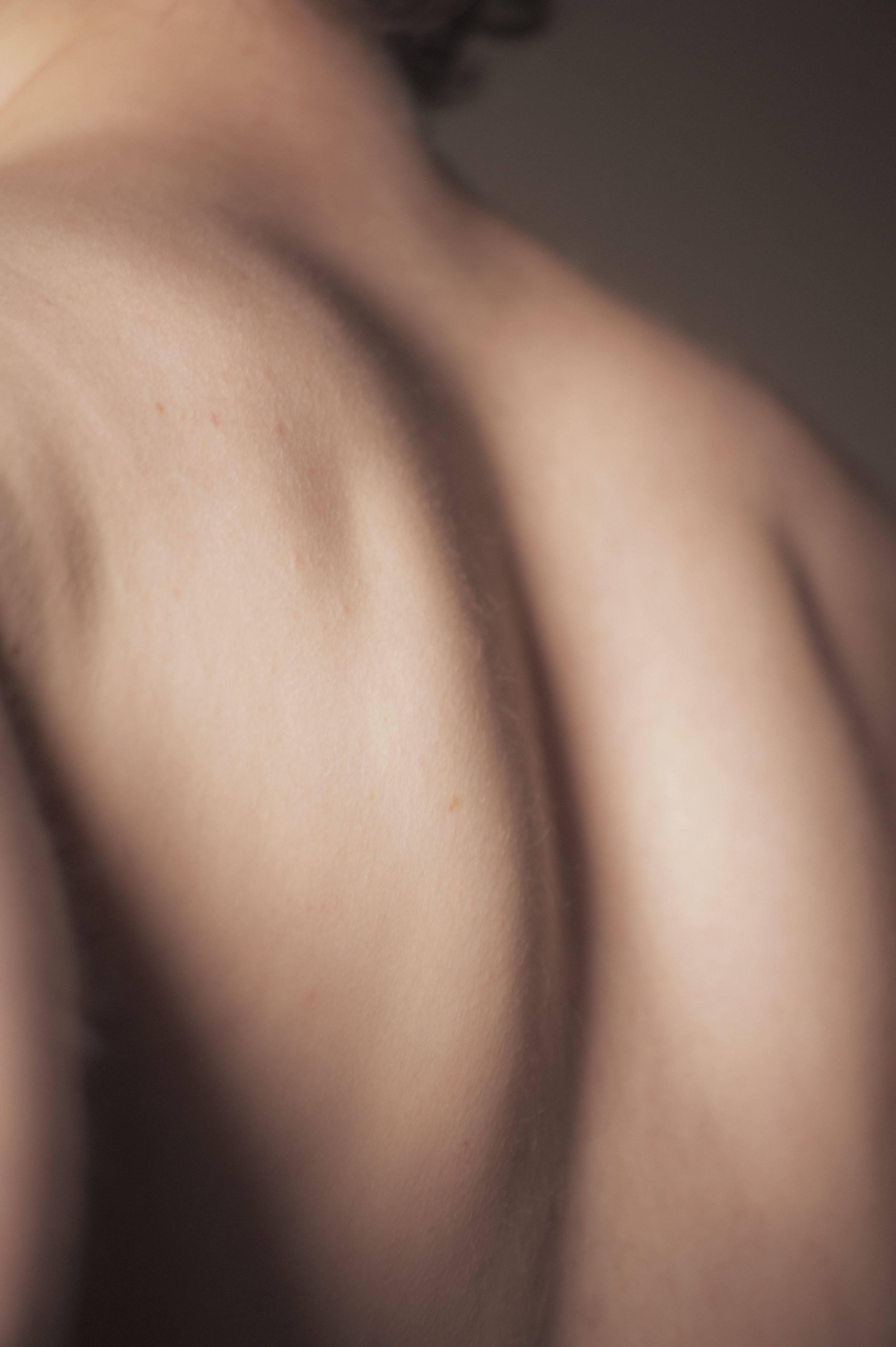 Close-up of smooth shoulder and upper back skin after professional back waxing
