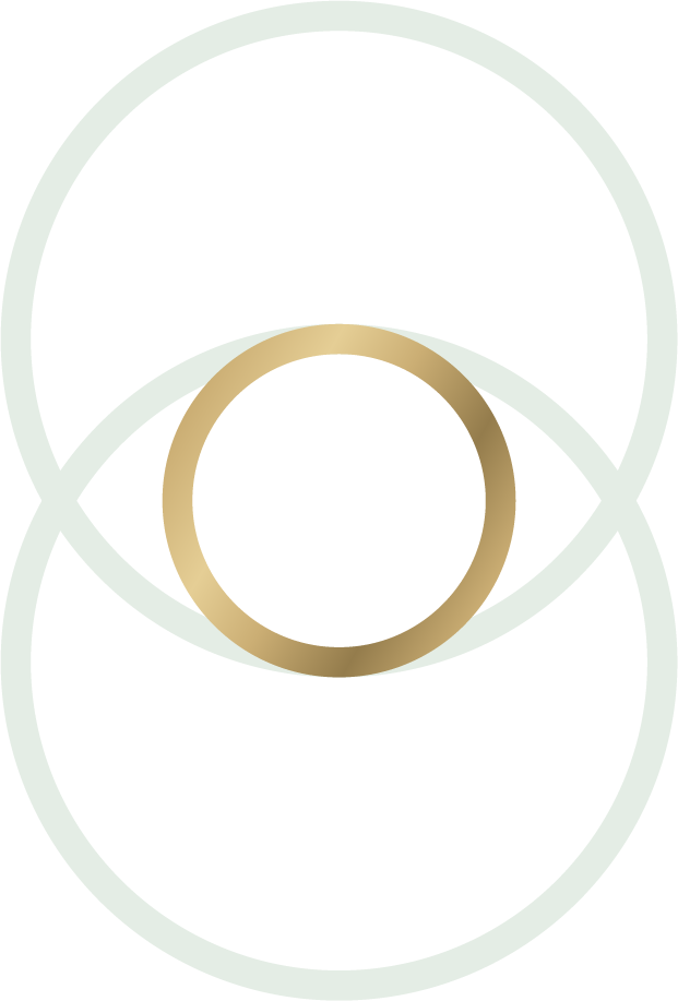 A close-up of a beige, round object with a slightly elongated shape, possibly a seed or nut, on a light background.