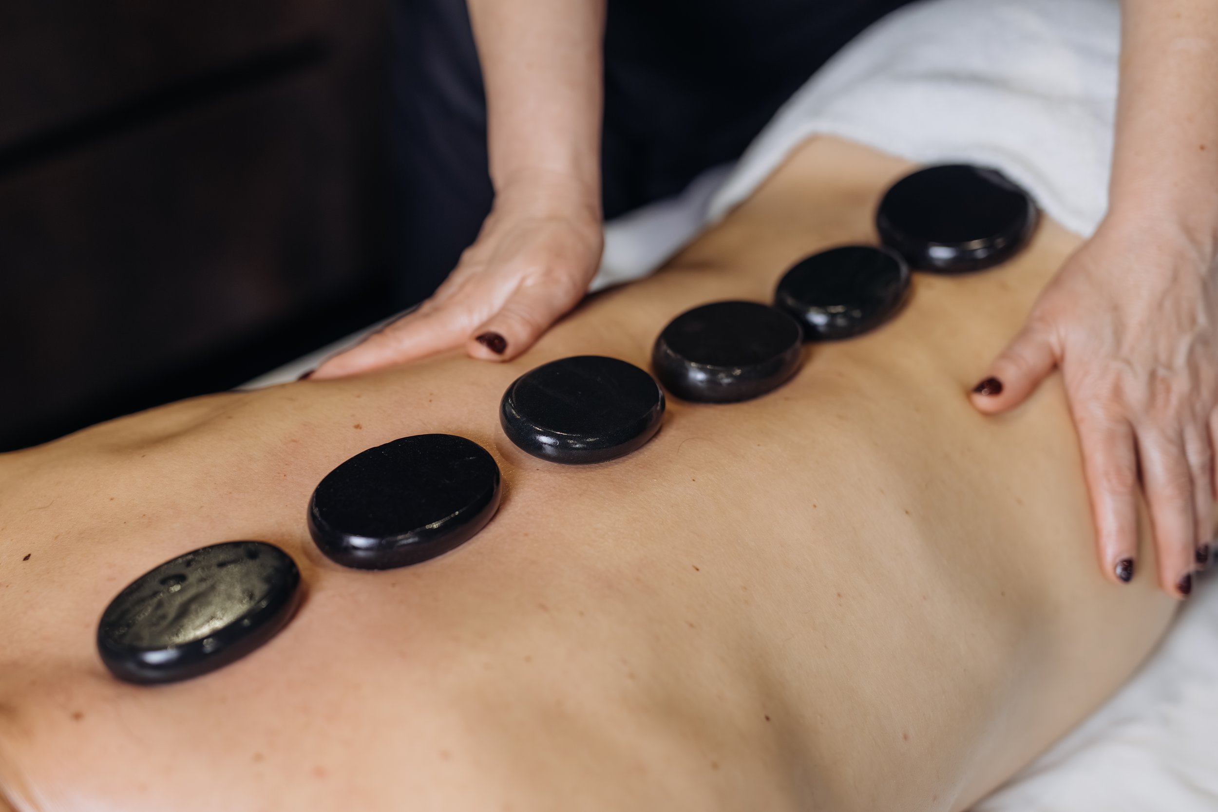 vecteezy_close-up-view-of-a-spa-treatment-featuring-smooth-black_78487445.jpg