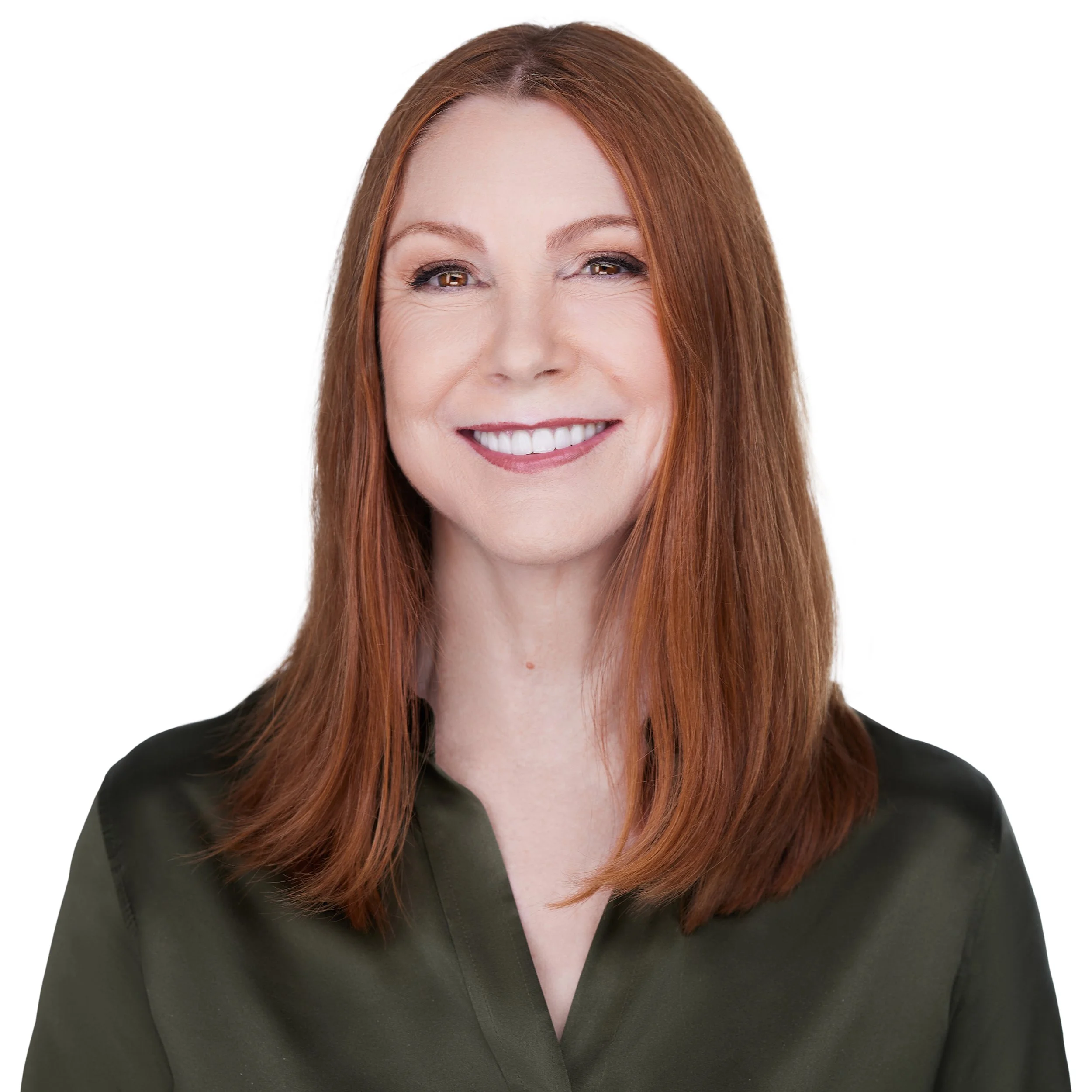 A woman with red hair, wearing a black blouse, smiling against a plain white background.