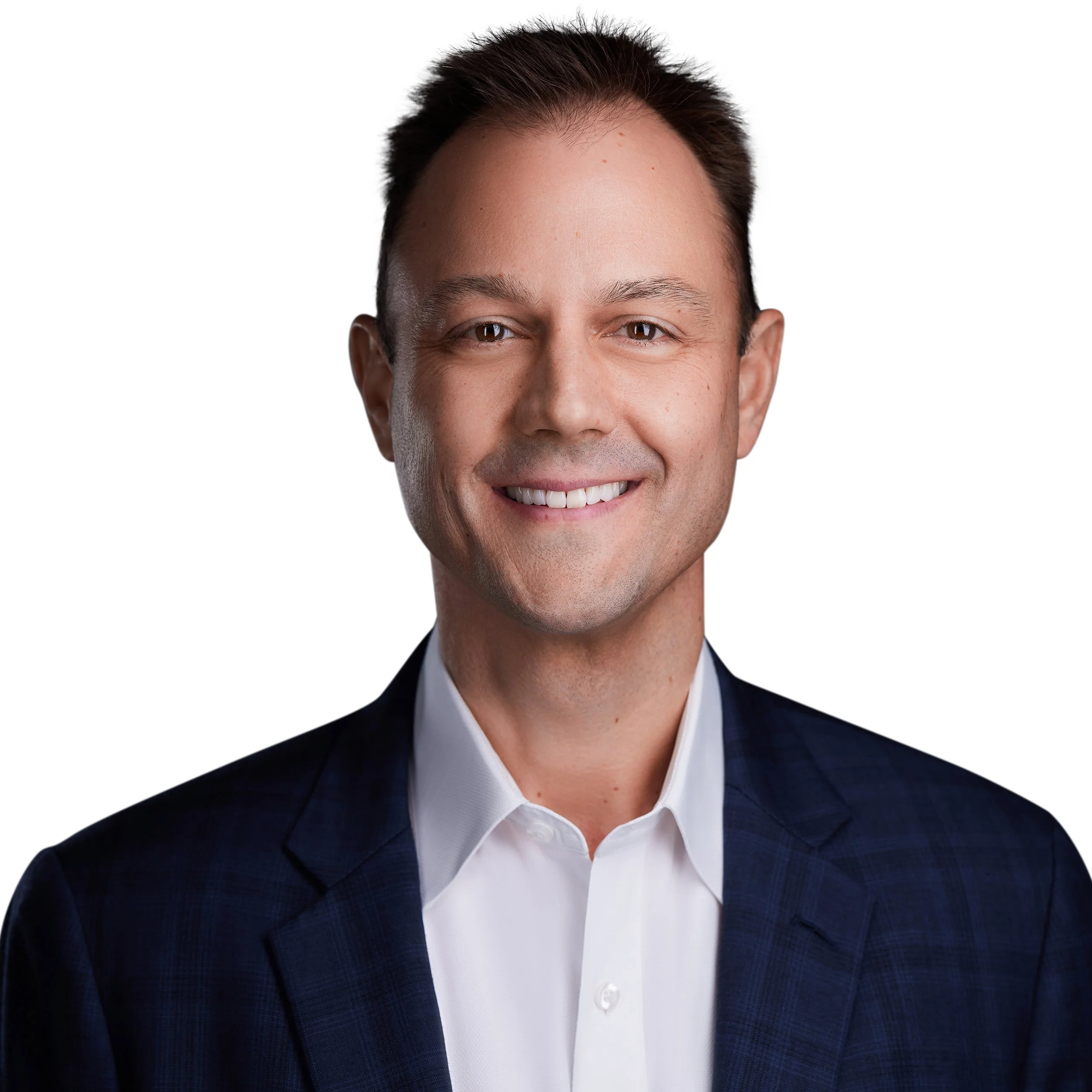A smiling man in a dark suit jacket and white shirt.