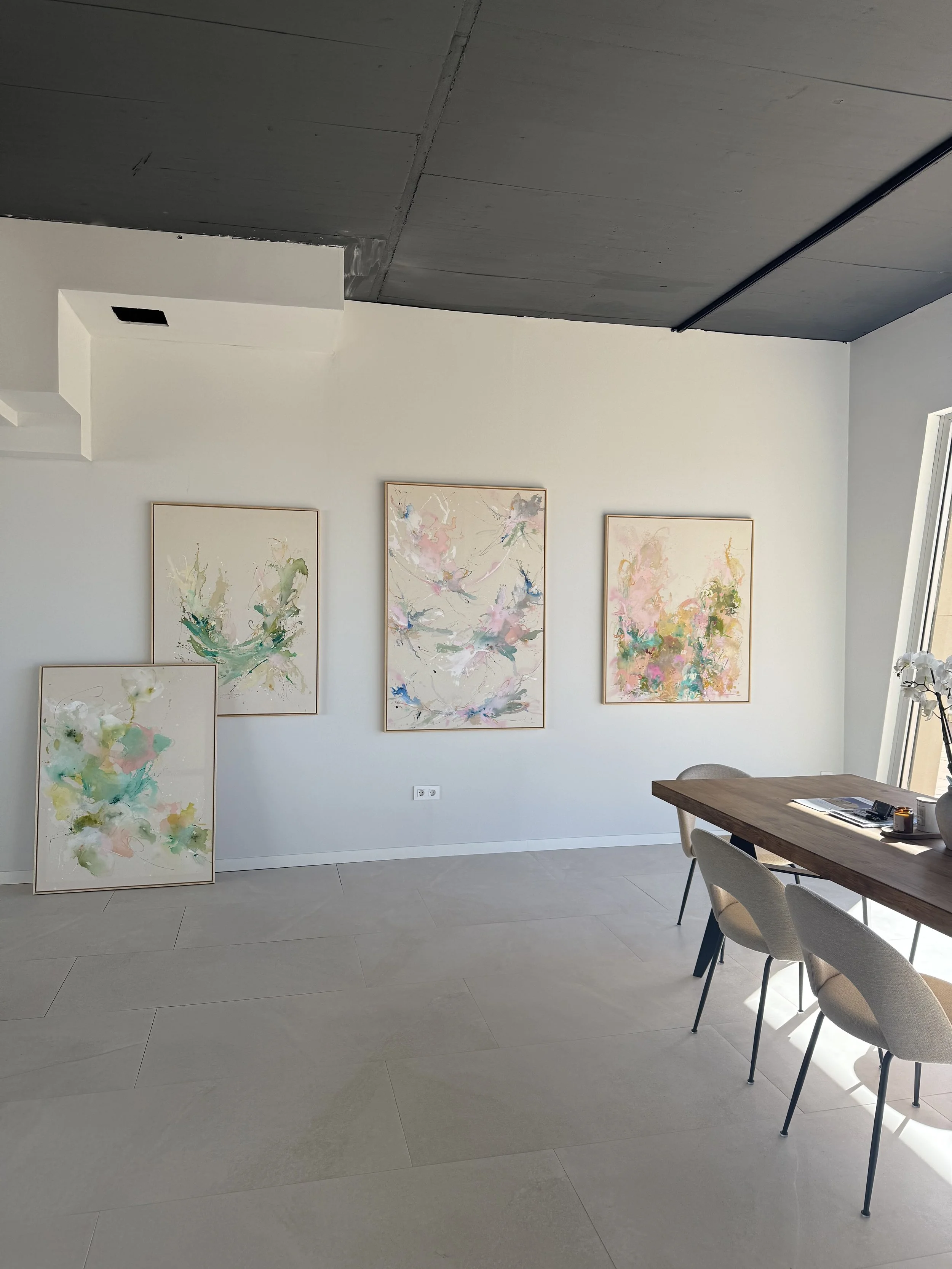 Original abstract paintings by Denize Jung presented in the Sunlife Homes Mallorca office, showcasing contemporary art inspired by Mediterranean living and natural textures.