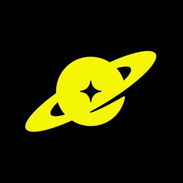A yellow planet with rings around it and a star-shaped symbol in the center, set against a black background.