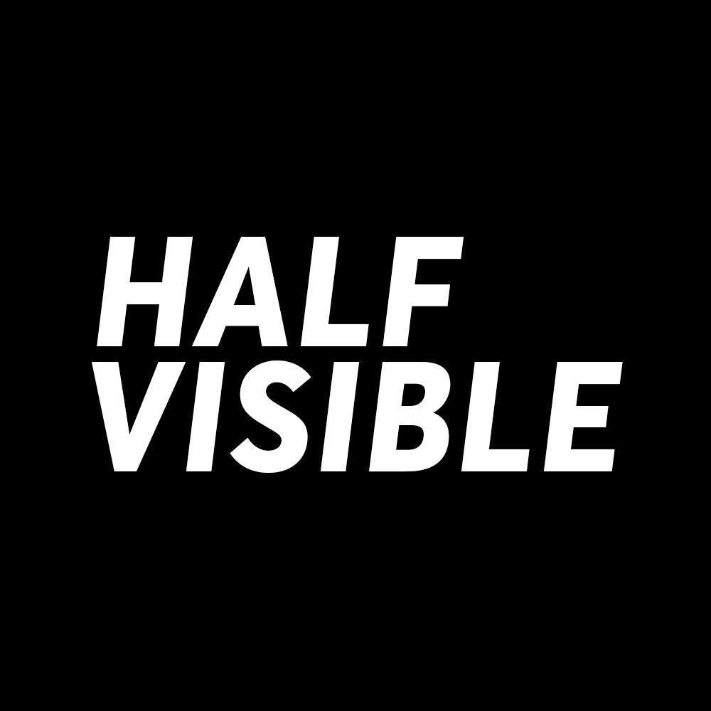 Black background with the text "HALF VISIBLE" in bold white capital letters, with a diagonal line cutting through the middle of the words.
