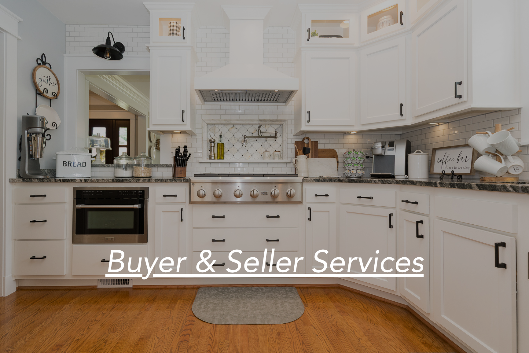 Modern kitchen with white cabinets, stainless steel stove, black handles, granite countertops, and various small appliances and decor items, with text overlay 'Buyer & Seller Services'.