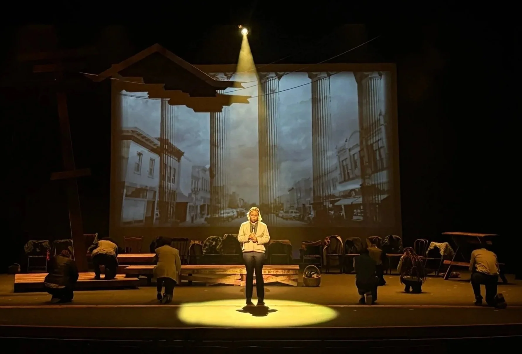 Cast in front of the projection design for the courthouse for the play “The Laramie Project” by Moises Kaufman and the Tectonic Theater Project