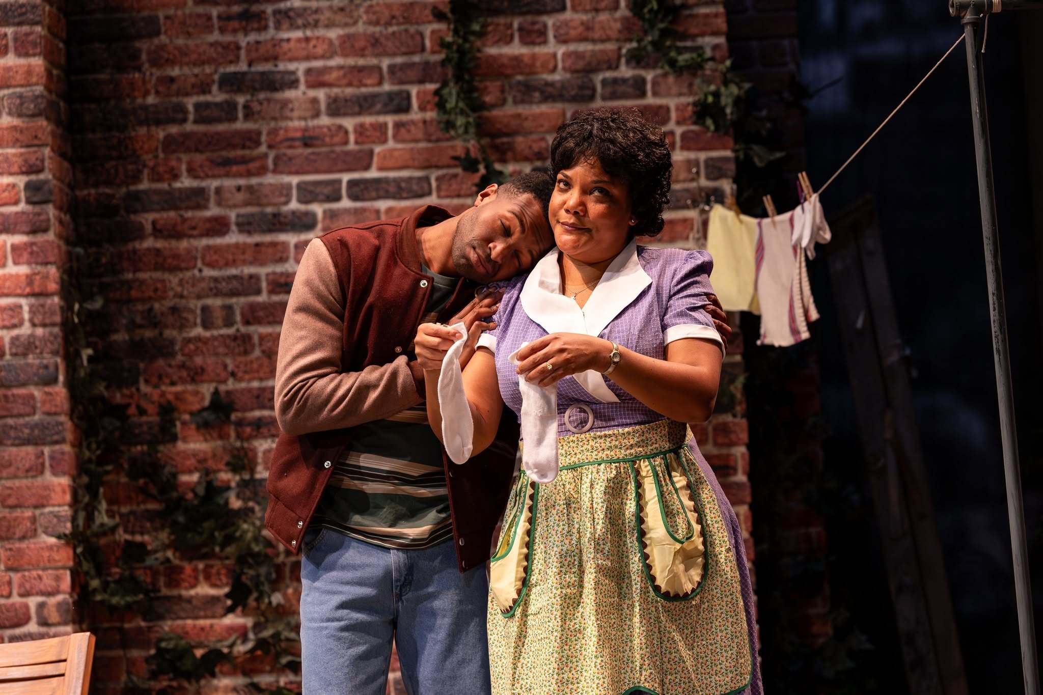 Rose and her son hanging laundry outside in the play “Fences” by August Wilson