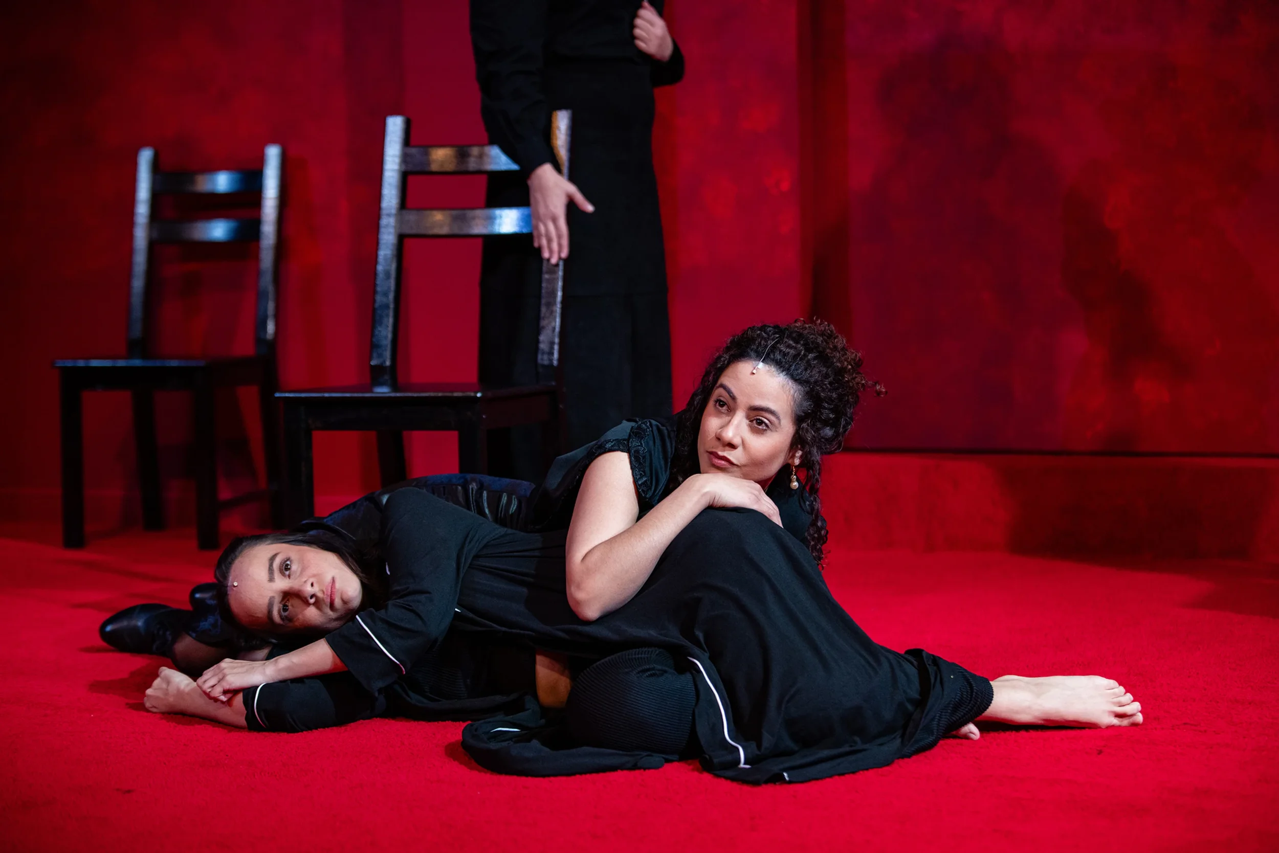 Close-up of actresses and black chairs for the play “La Casa de Bernarda Alba” by Federico García Lorca