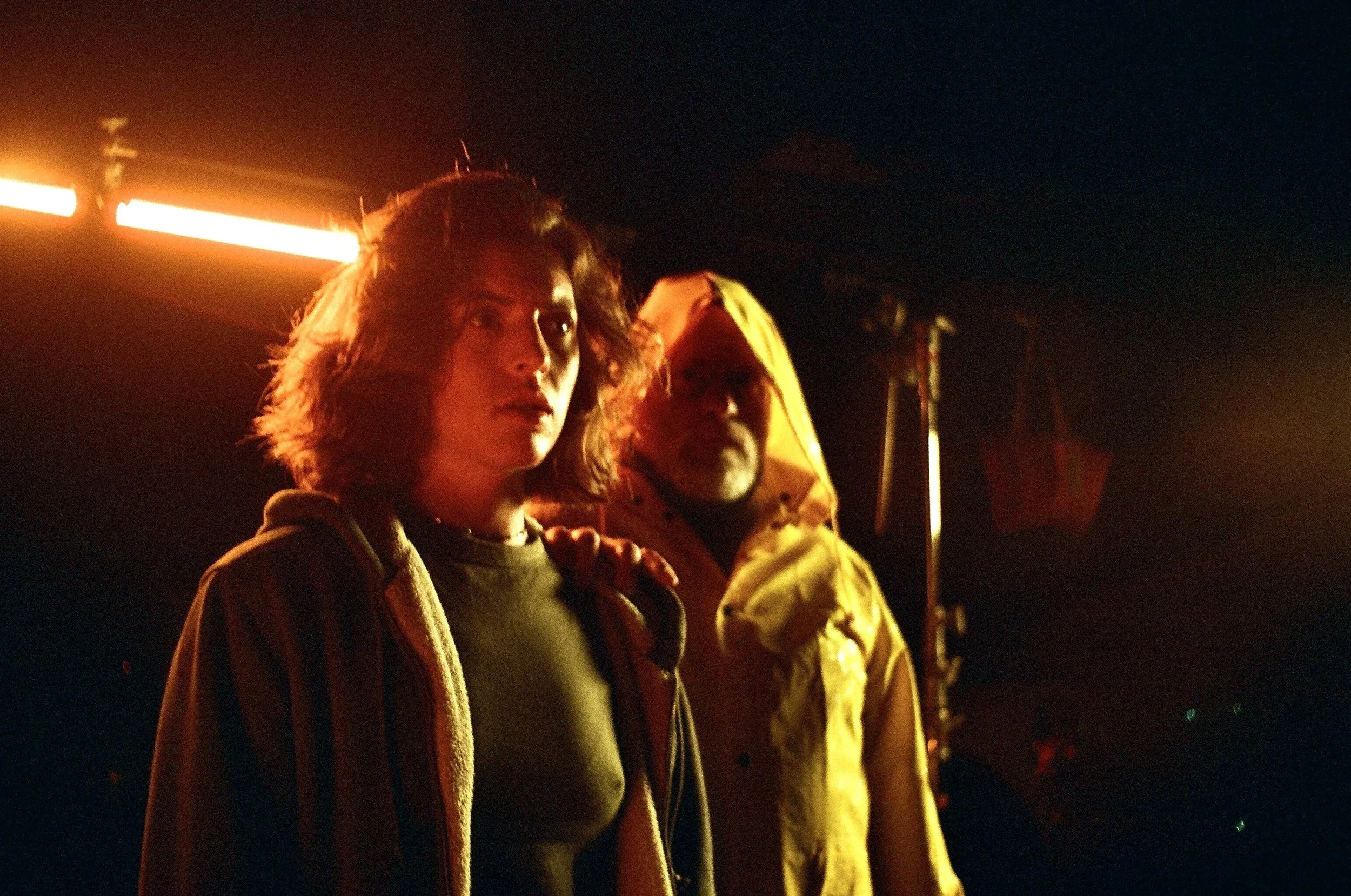 Behind the scenes shot of two characters in yellow test lighting for the film “Wolf in Lamb’s Skin.”