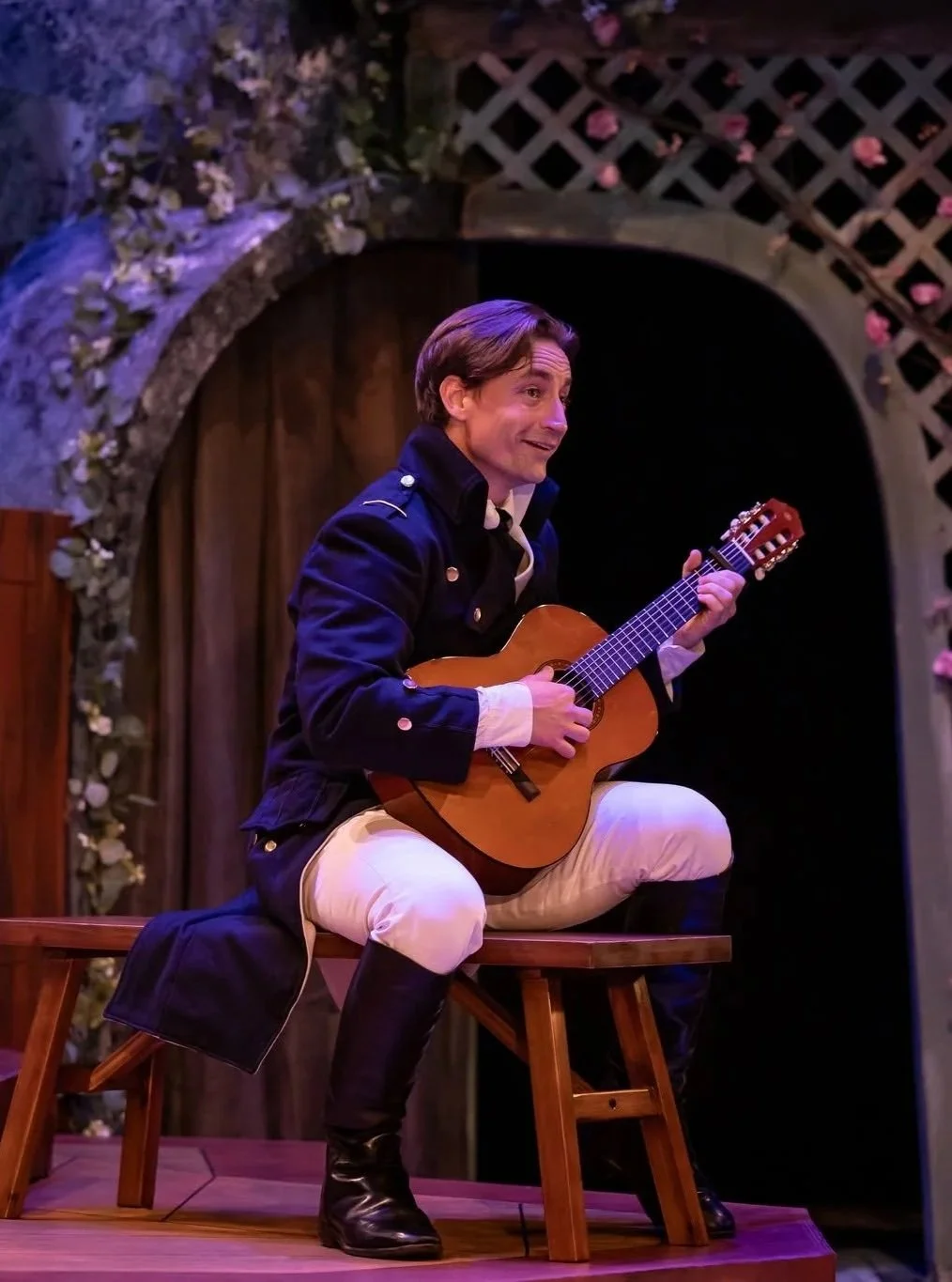 Captain Wentworth serenading the audience from a bench in the play “Persuasion” by Jane Austen, adapted by Sarah Rose Kearns