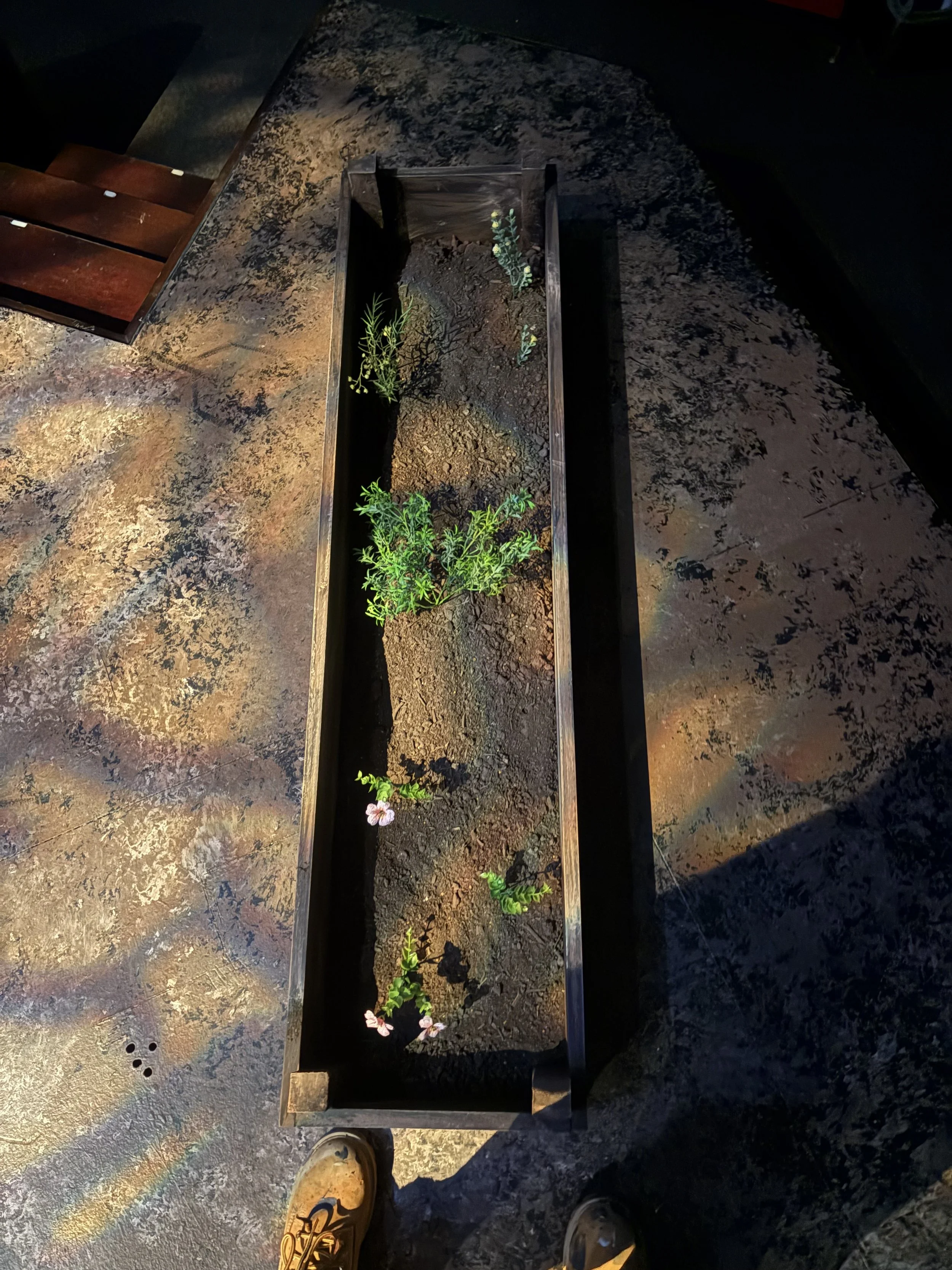 Close up process photo of creating garden beds for Rose to use onstage during the play “Fences” by August Wilson