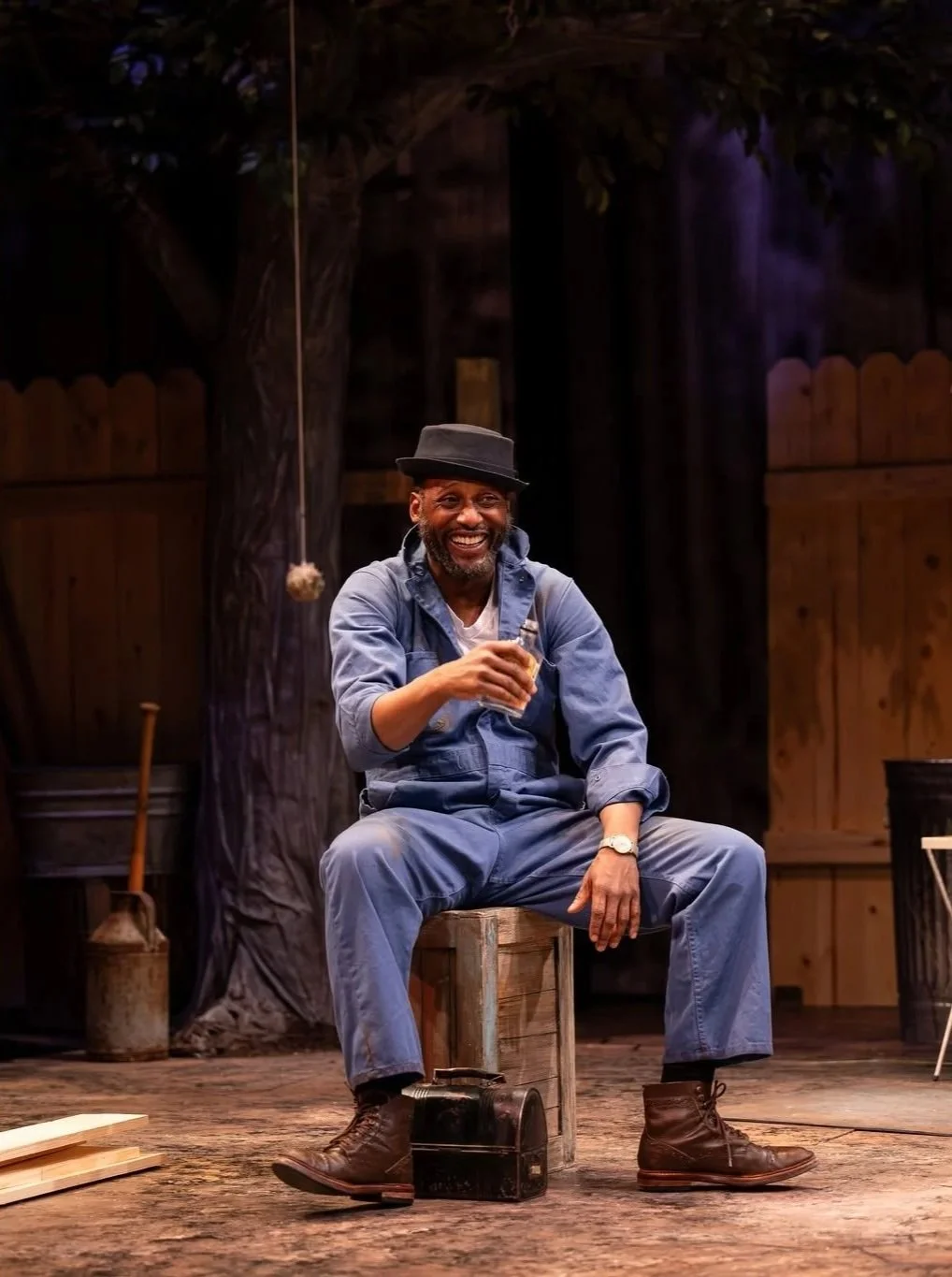 Close-up of Bono drinking onstage in the play “Fences” by August Wilson