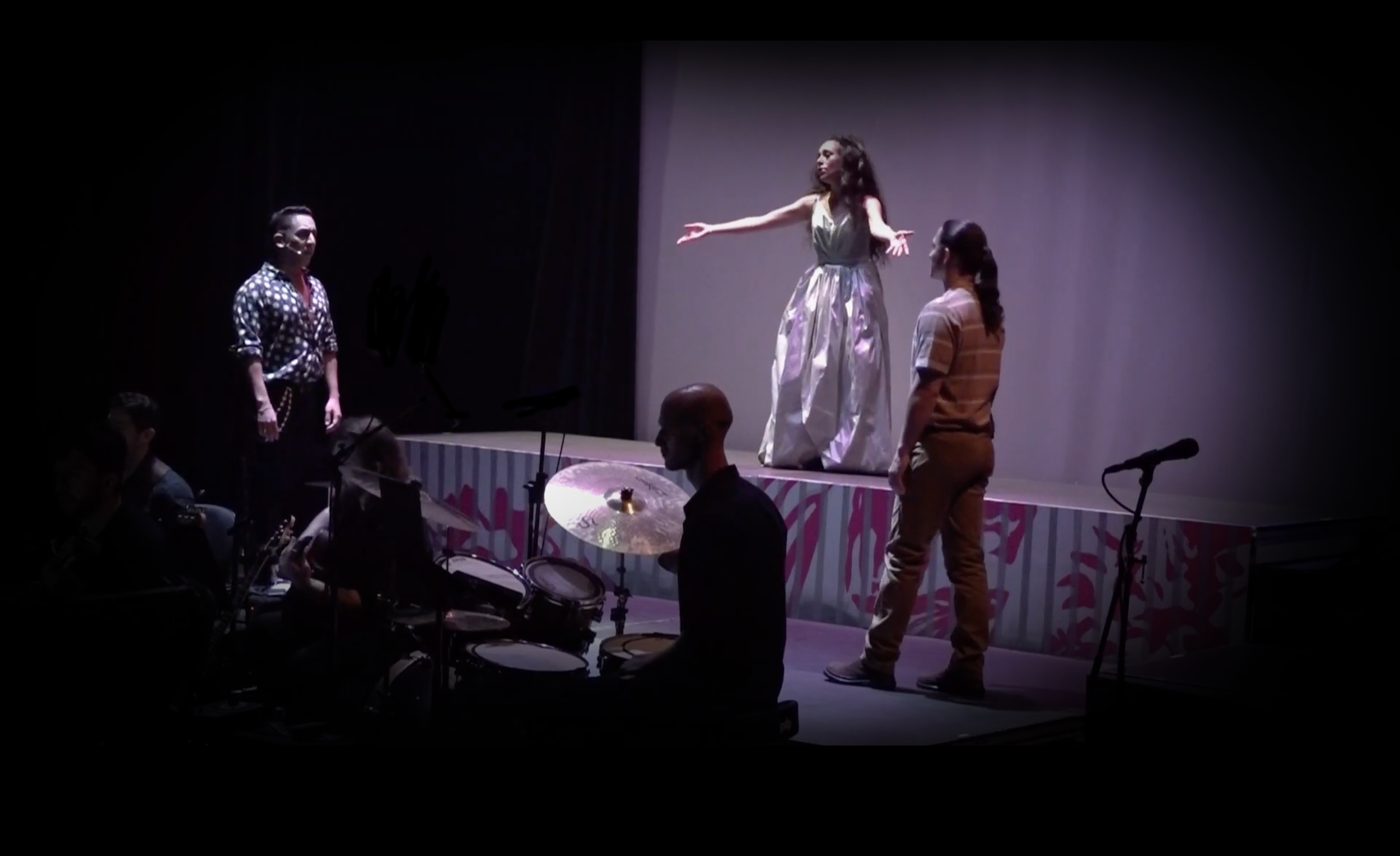 Spotlit shot of singers on the upstage platform for the world premiere Opera “The Magic Hummingbird”