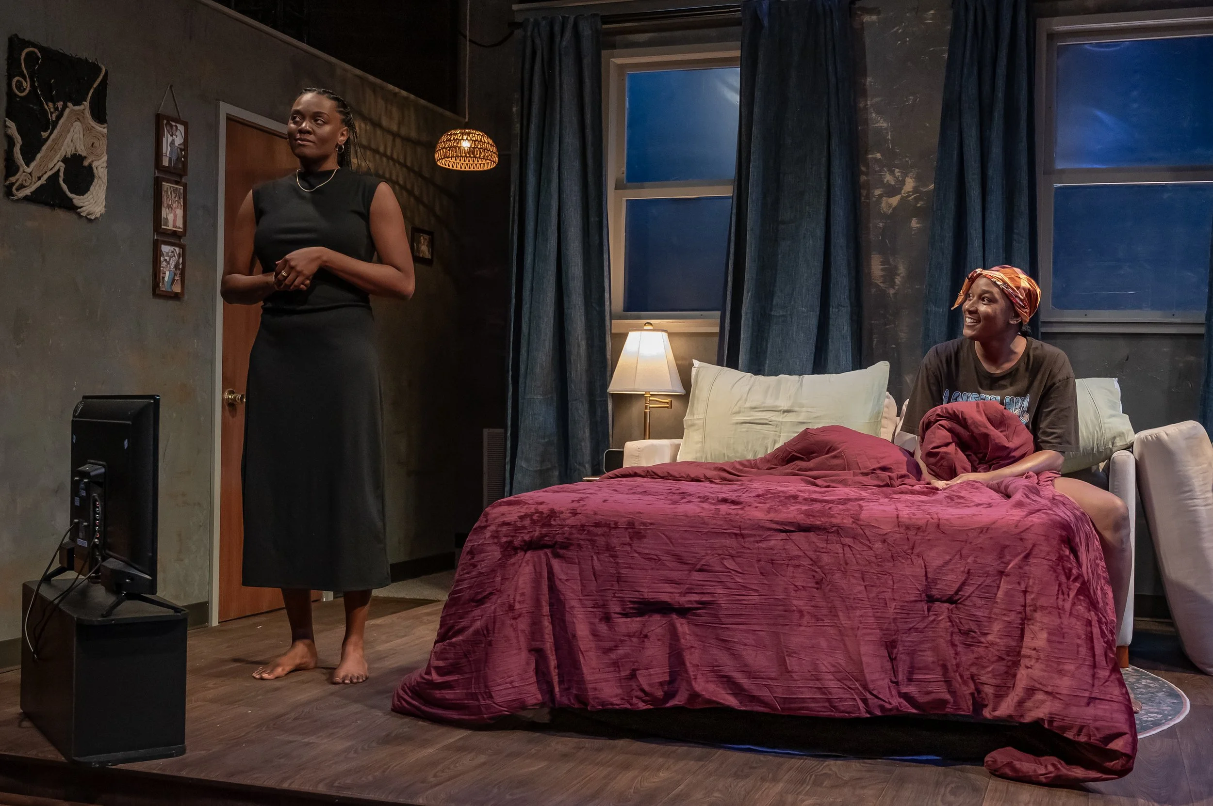 Wide-shot of the living room set featuring set dressing, pulled out couch bed, and practicals for the play “Furlough’s Paradise” by A.K. Payne