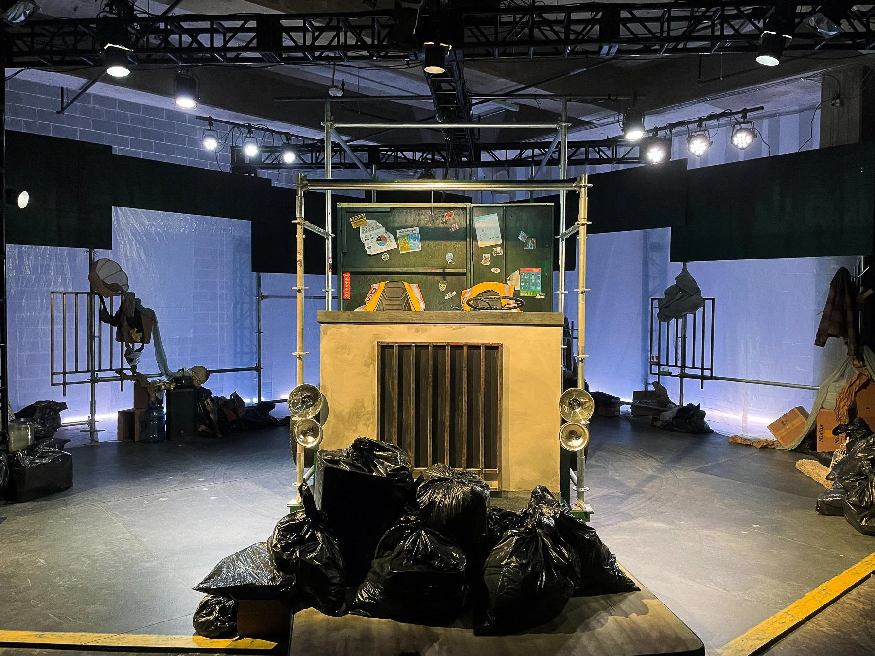 Wide-shot of the garbage truck surrounded by the sculpted trash piles for the props design of the play “The Garbologists” by Lindsay Joelle