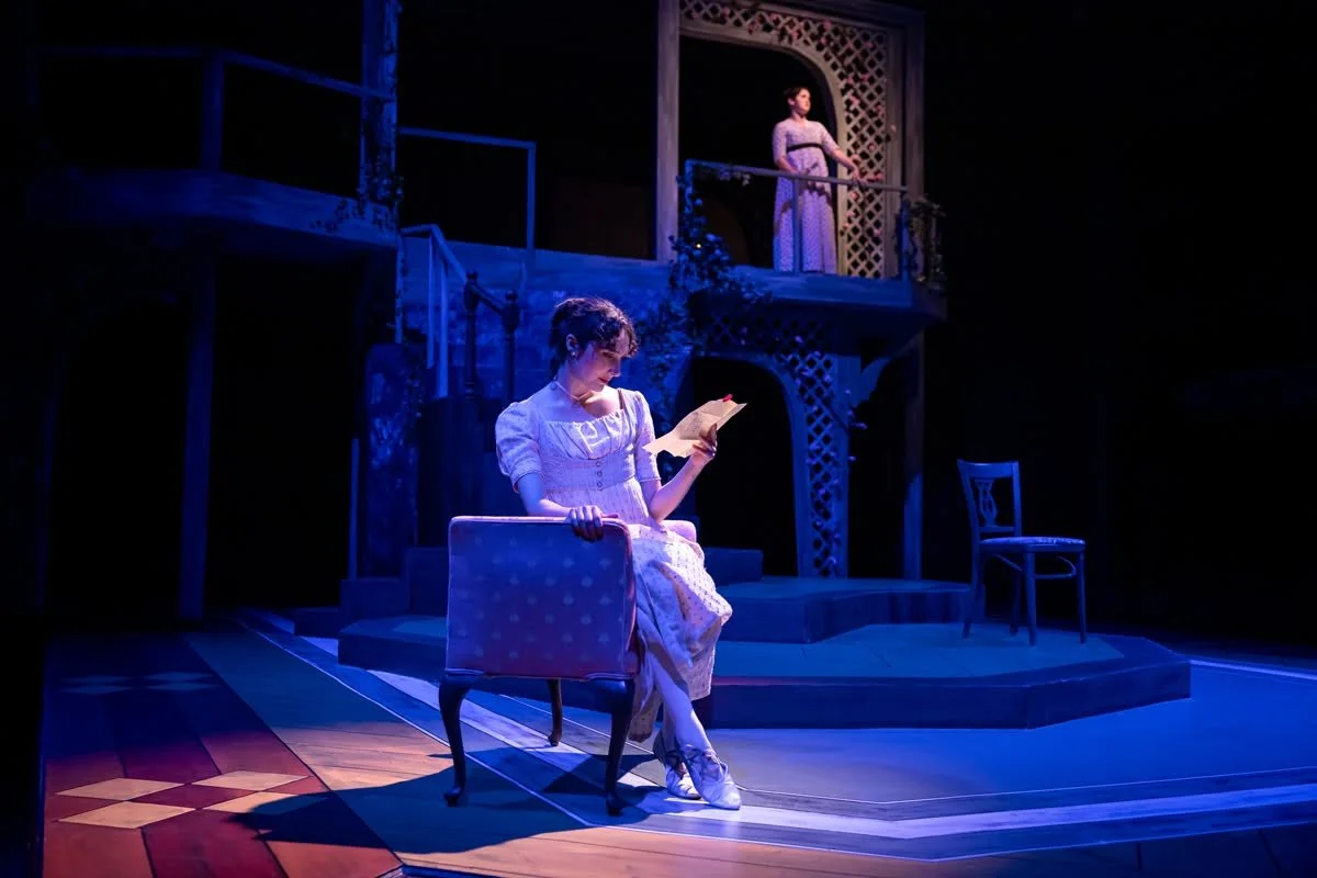Anne reading a letter on a chaise in the play “Persuasion” by Jane Austen, adapted by Sarah Rose Kearns