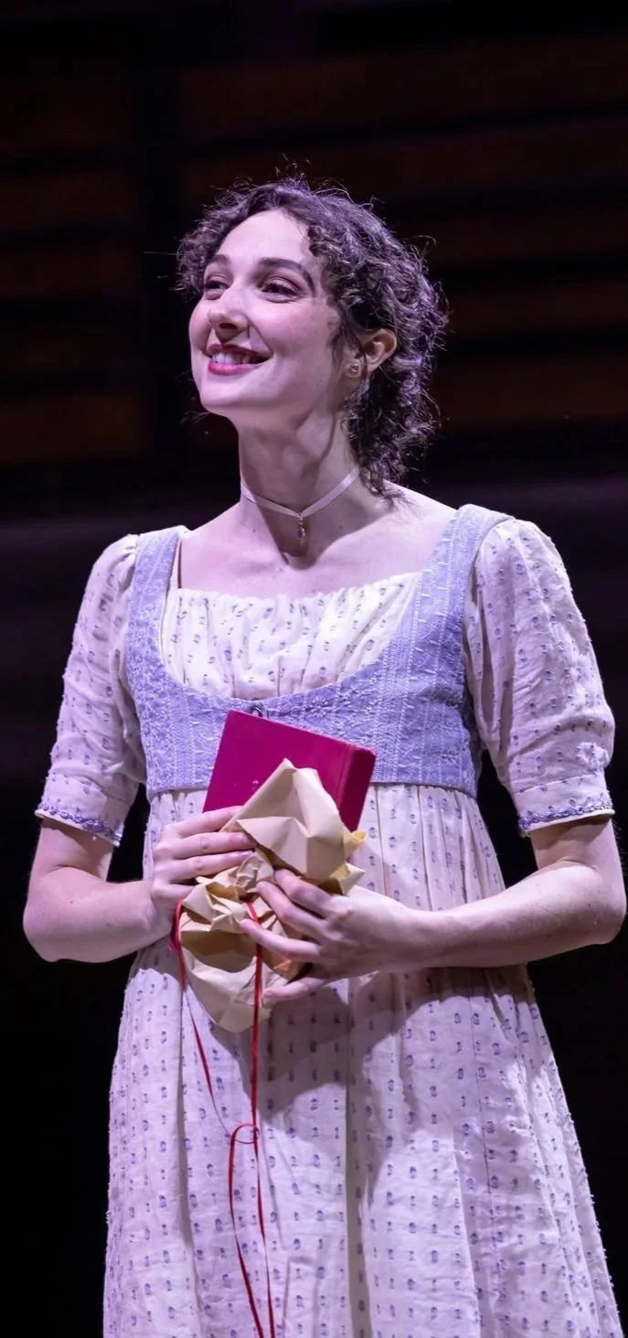 Actress holding a gifted book in the play “Persuasion” by Jane Austen, adapted by Sarah Rose Kearns