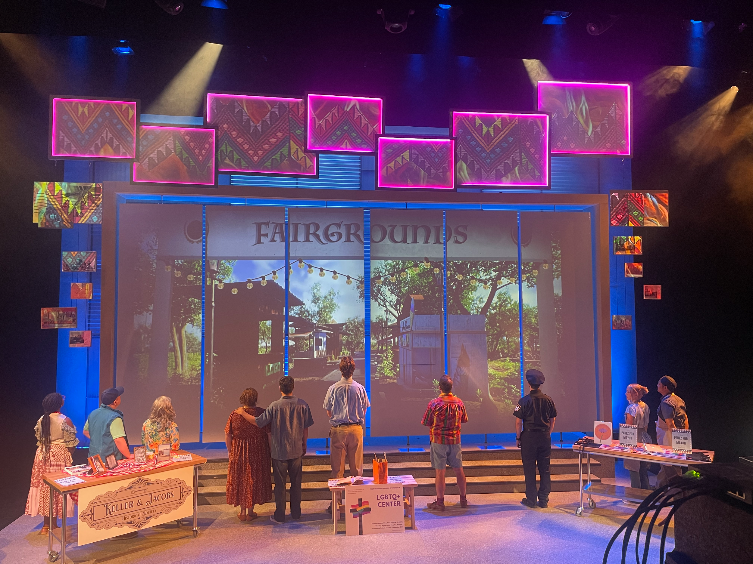 Cast gathered at the fairgrounds, emphasized with the projection design, for the world premiere musical “Postcard American Town”