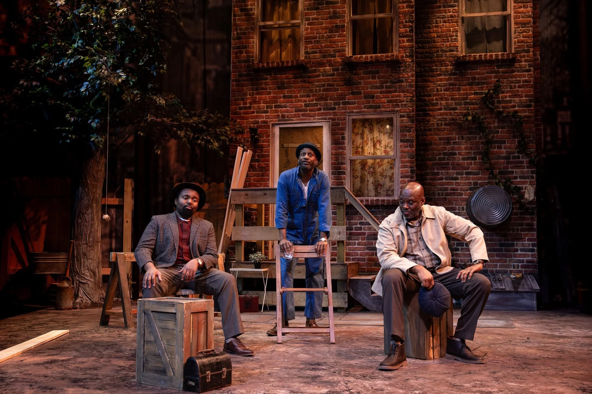 Troy, Bono, and Lyons in the yard in the play “Fences” by August Wilson