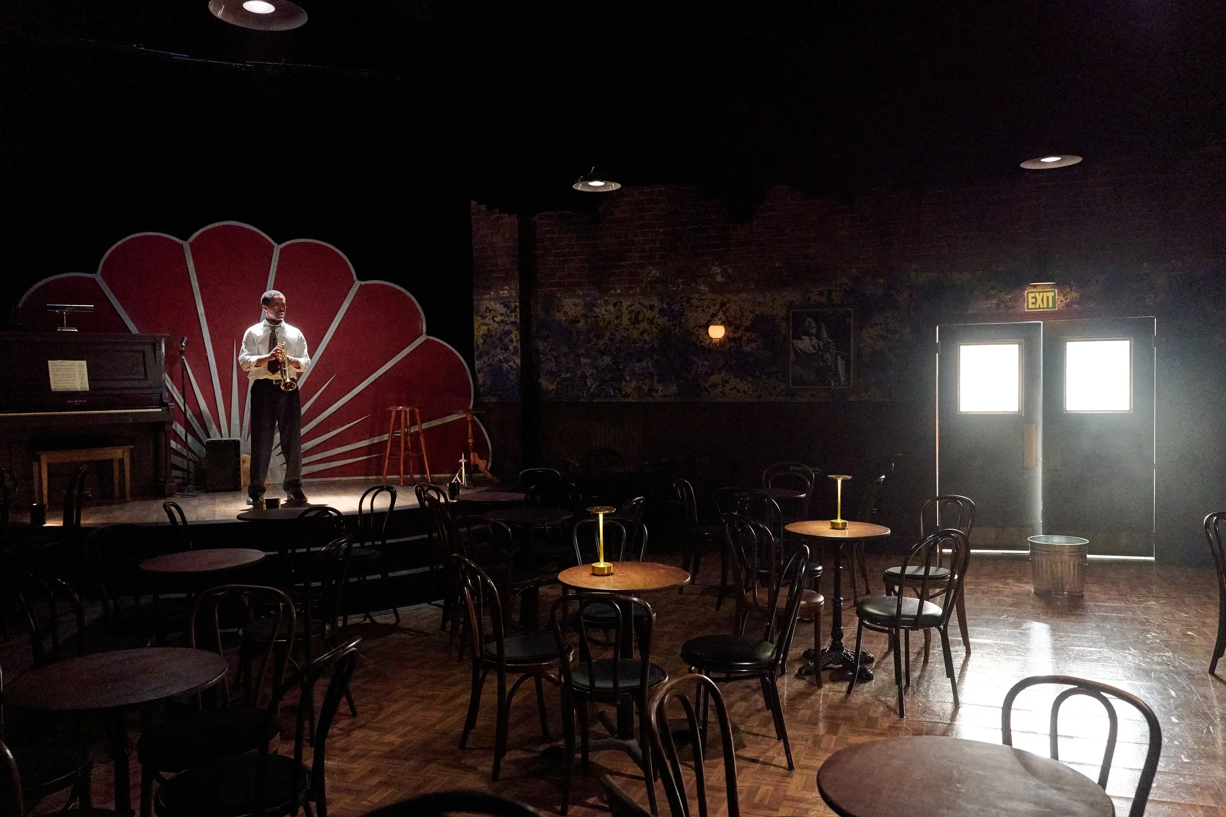 Wide-shot of the bandshell, seating area, and lit through double doors in the set of the play “Paradise Blue” by Dominique Morisseau