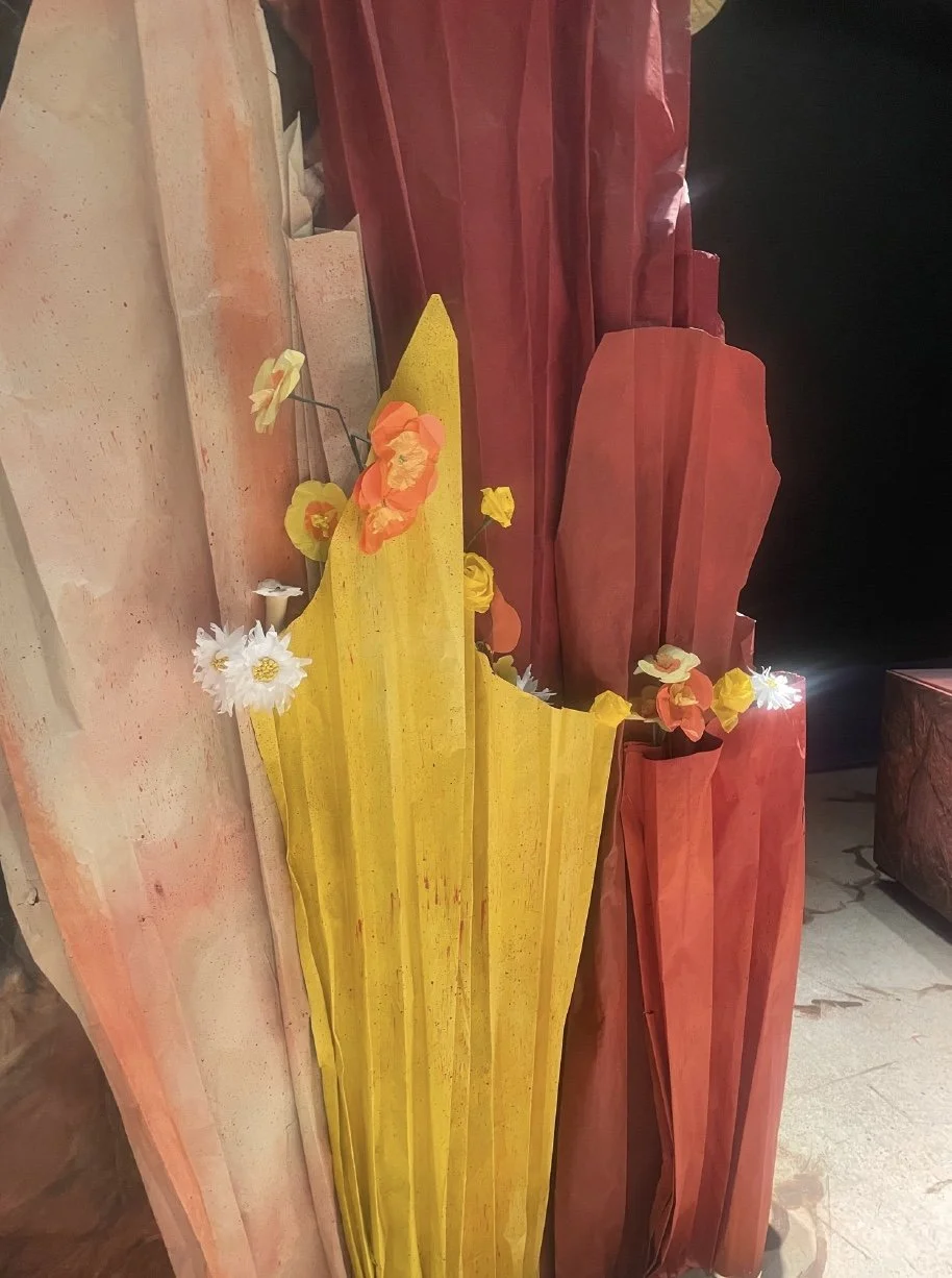 A close-up of the set decorated with tissue paper flowers made for the opera “The Pirates of Penzance”