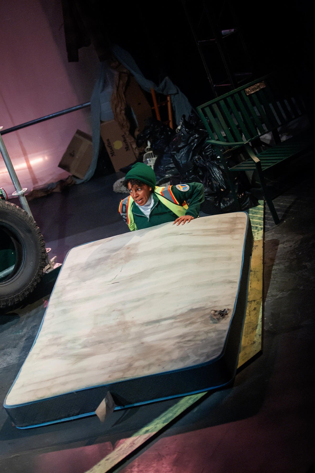Marlowe underneath a dirty mattress in the play “The Garbologists” by Lindsay Joelle