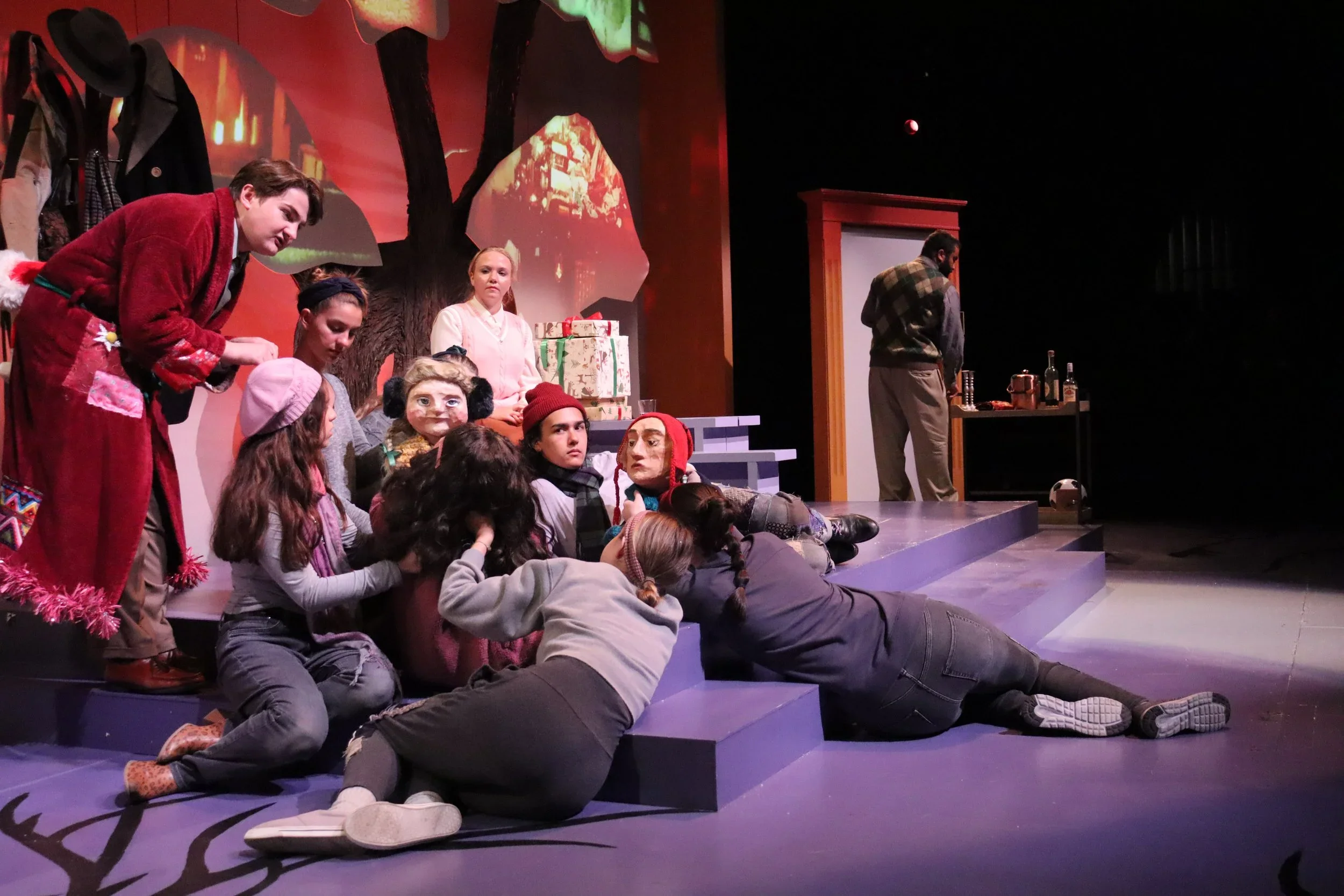 A family scene with Bunraku style puppets and puppeteers on the set design for the play “The Long Christmas Ride Home” by Paula Vogel