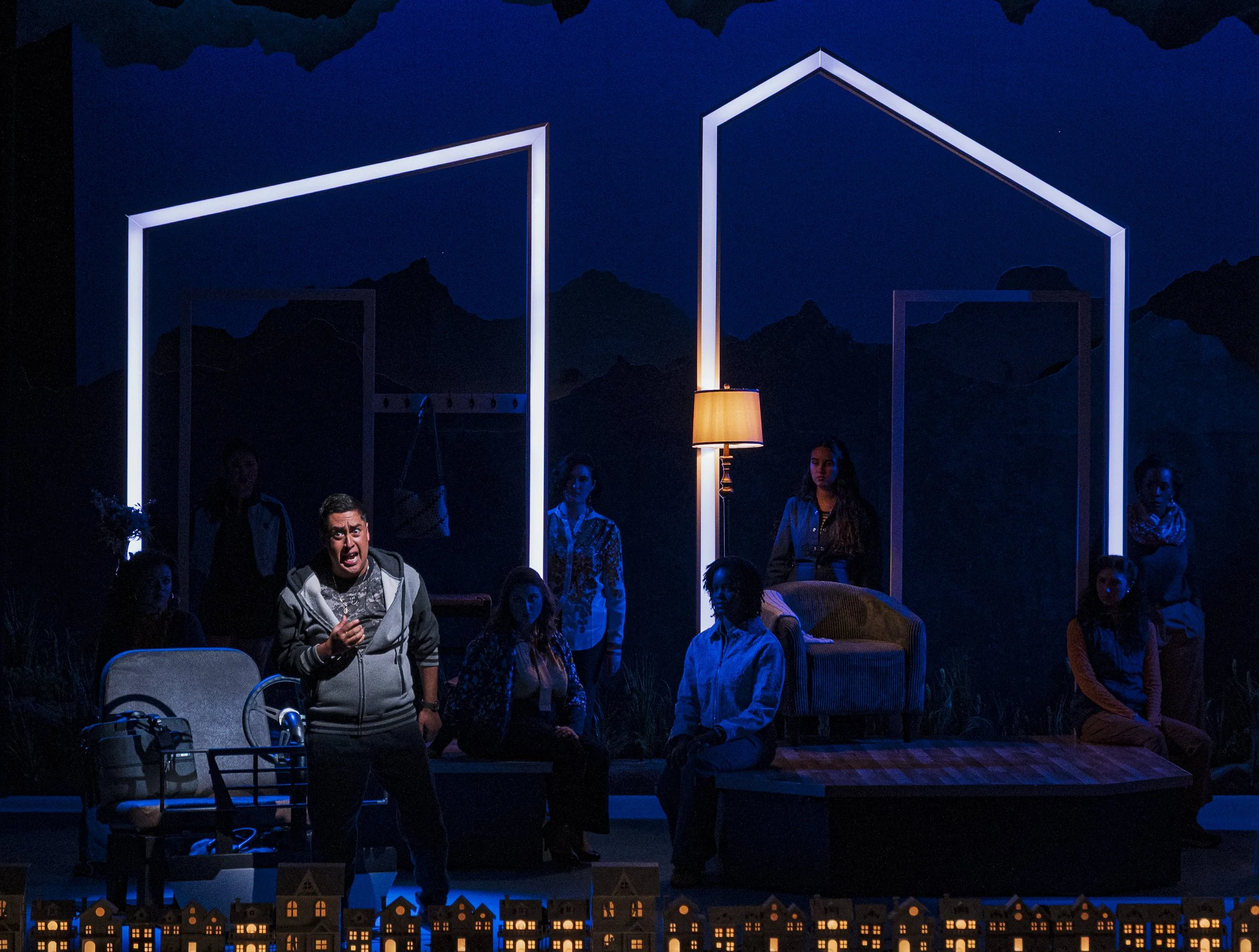 A spotlit shot of the car in the opera “The Knock”