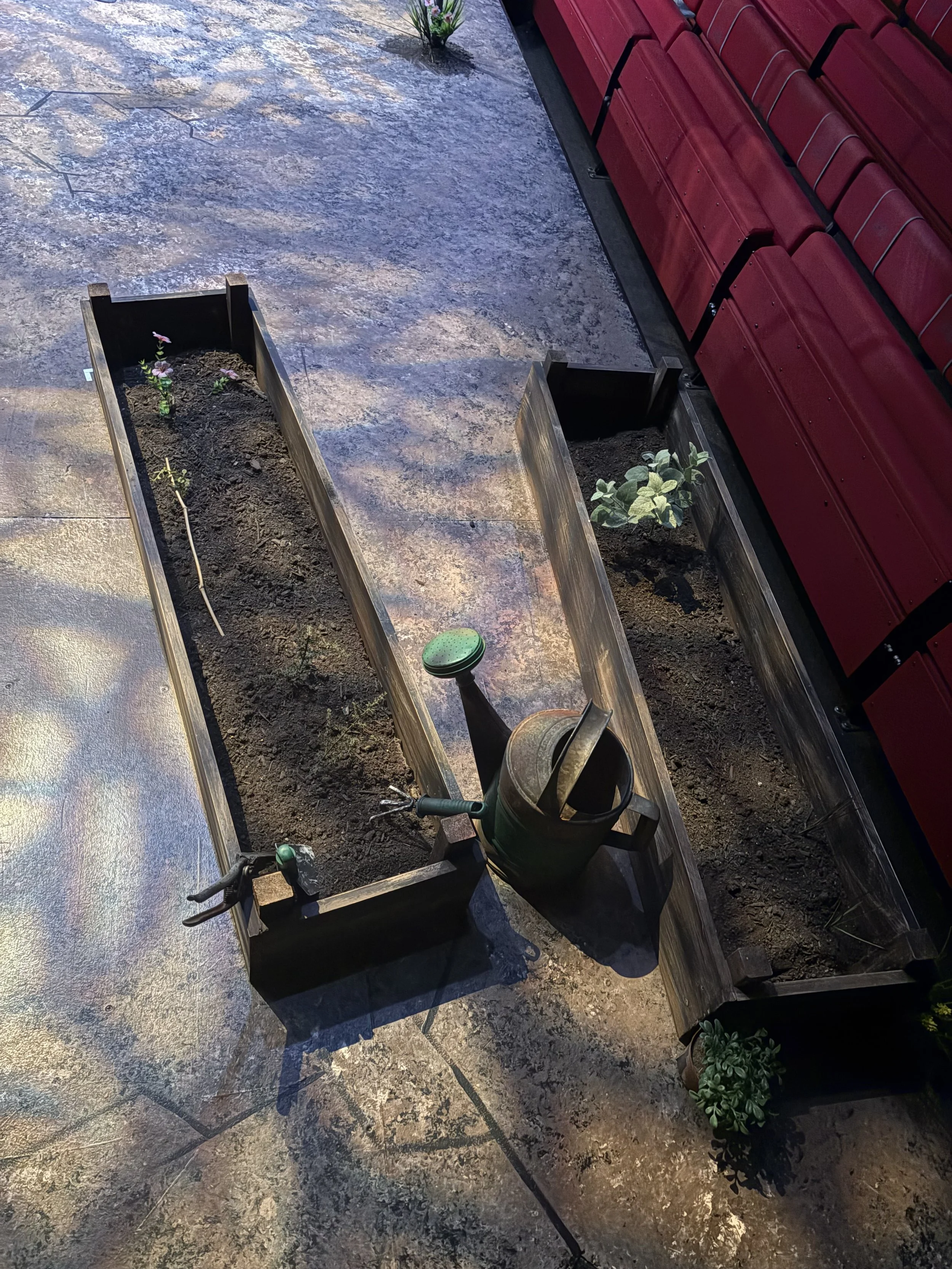 Close up process photo of creating garden beds for Rose to use onstage during the play “Fences” by August Wilson