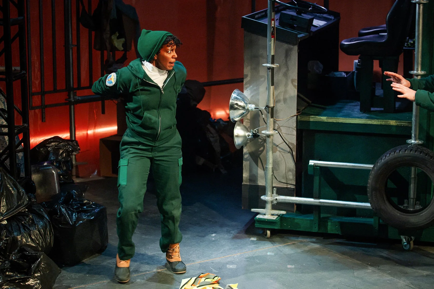 Marlowe next to a pile of trash bags in the play “The Garbologists” by Lindsay Joelle