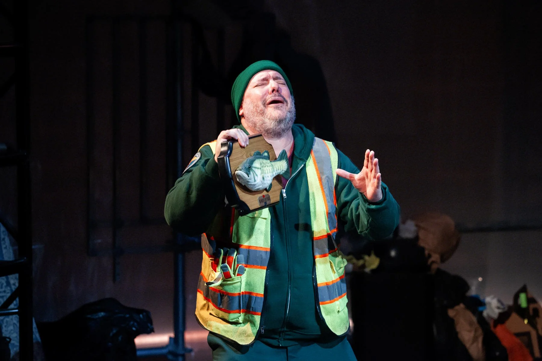 Danny playing with a singing fish prop in the play “The Garbologists” by Lindsay Joelle