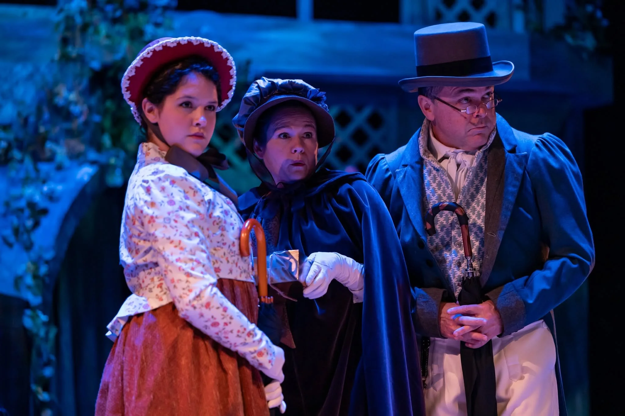 Ensemble holding umbrellas in the play “Persuasion” by Jane Austen, adapted by Sarah Rose Kearns