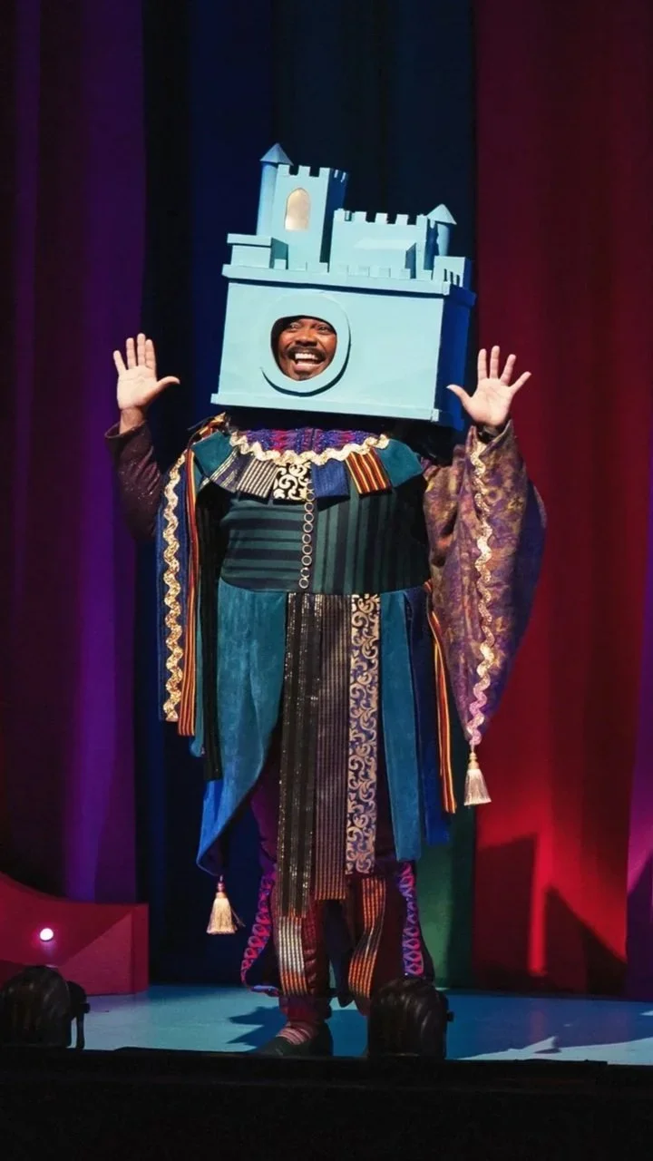 The narrator in a castle hat in the opening scene of the opera “Once Upon a Mattress”