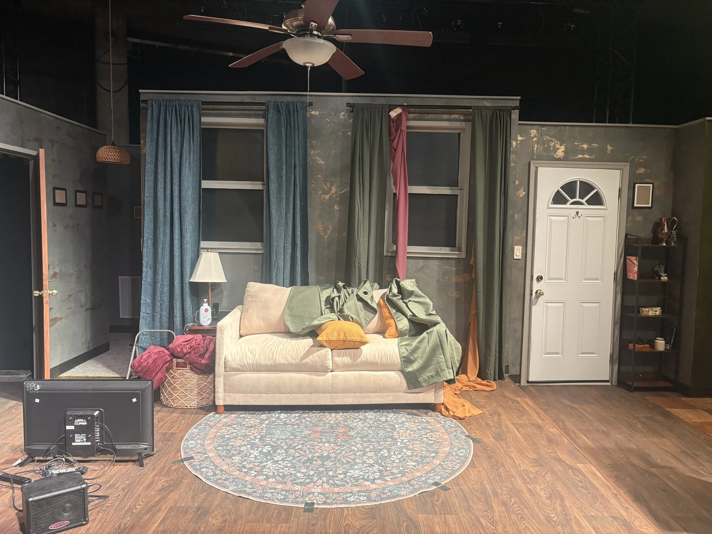 Hiding the final show fabrics behind set dressing curtains onstage for the production of the play “Furlough’s Paradise” by A.K. Payne