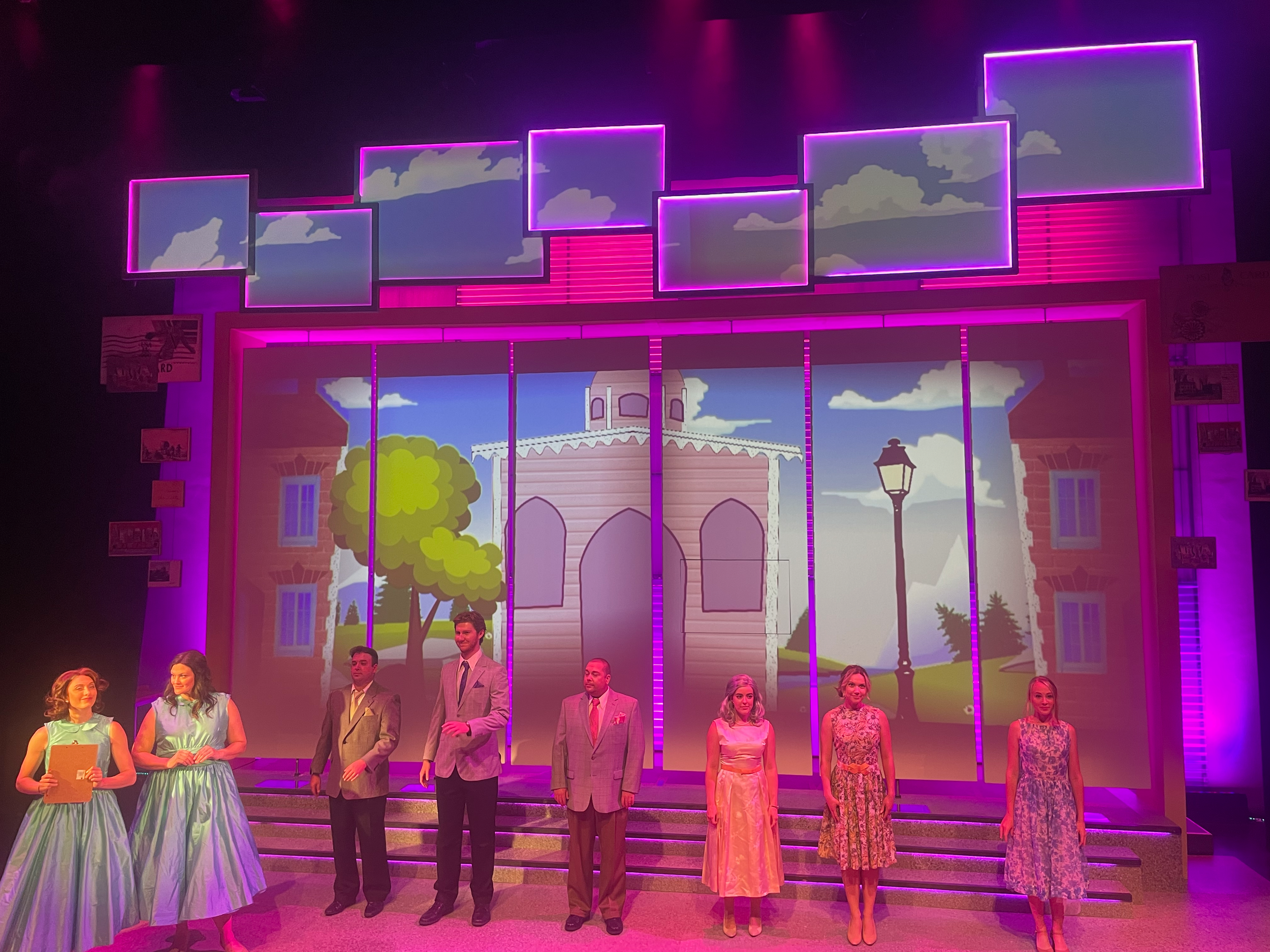 Pink dream sequence scene backed by projections for the world premiere musical “Postcard American Town”