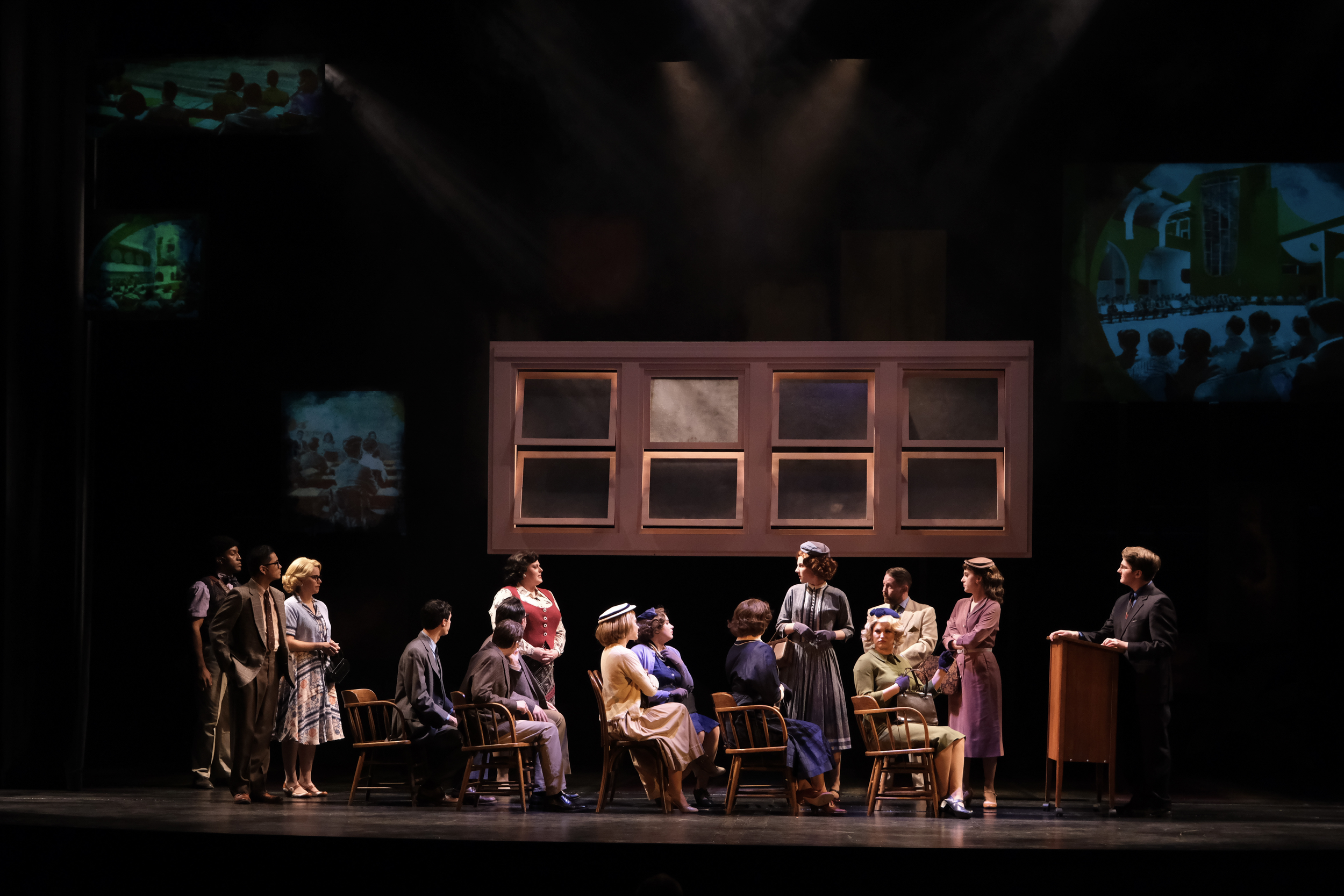 Professors and parents gathered under a window set piece in chairs on the set for the world premiere musical “In a Sunshine State.”