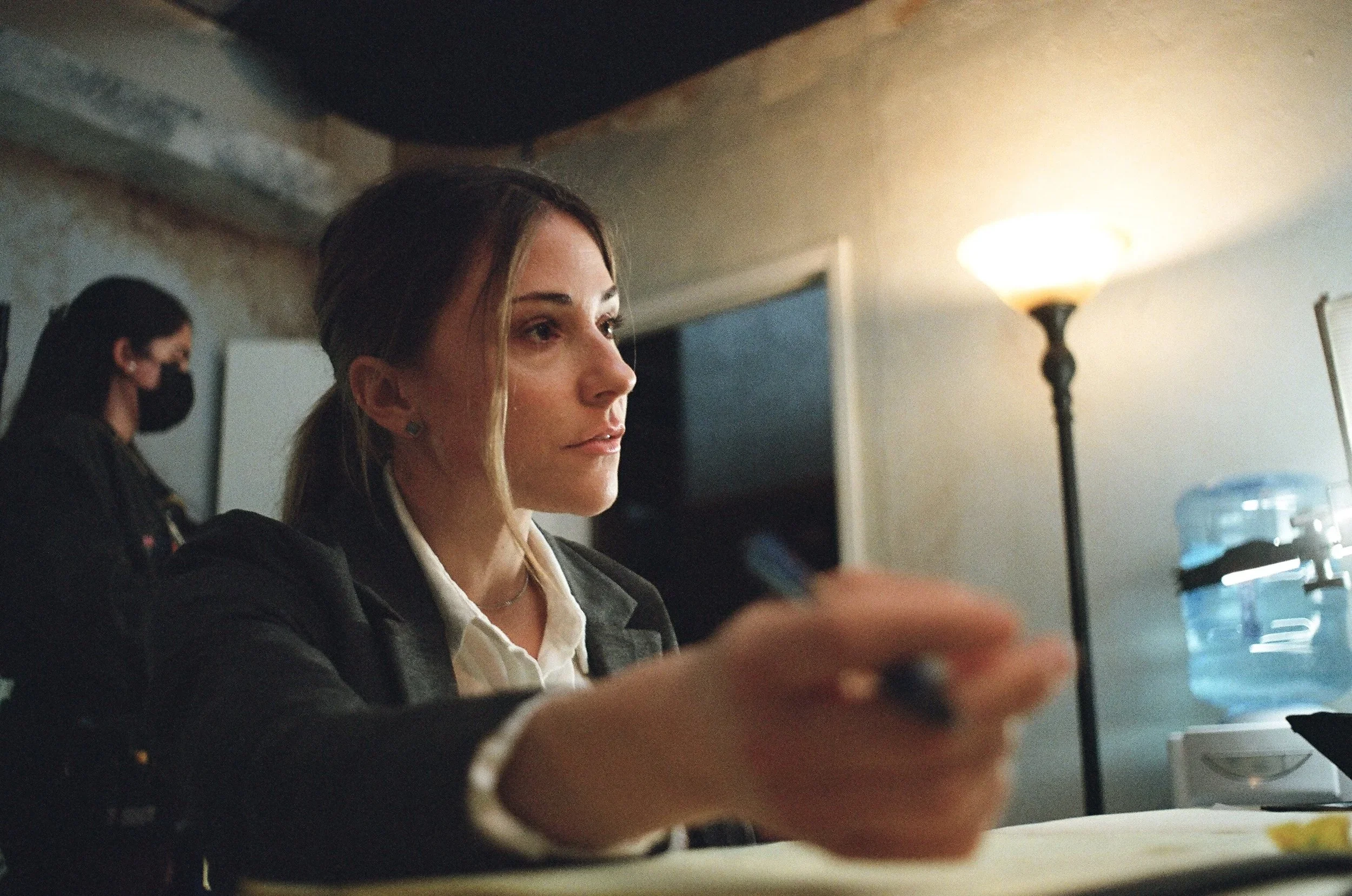 BTS of the detective and film crew in the built interrogation room set on the film “Wolf in Lamb’s Skin.”