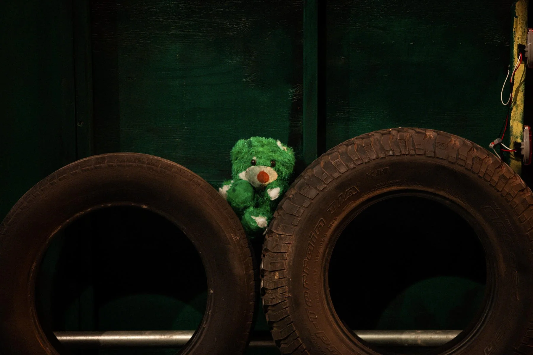 Dressing on the side of the garbage truck including tires and an old stuffed animal on the set of the play “The Garbologists” by Lindsay Joelle