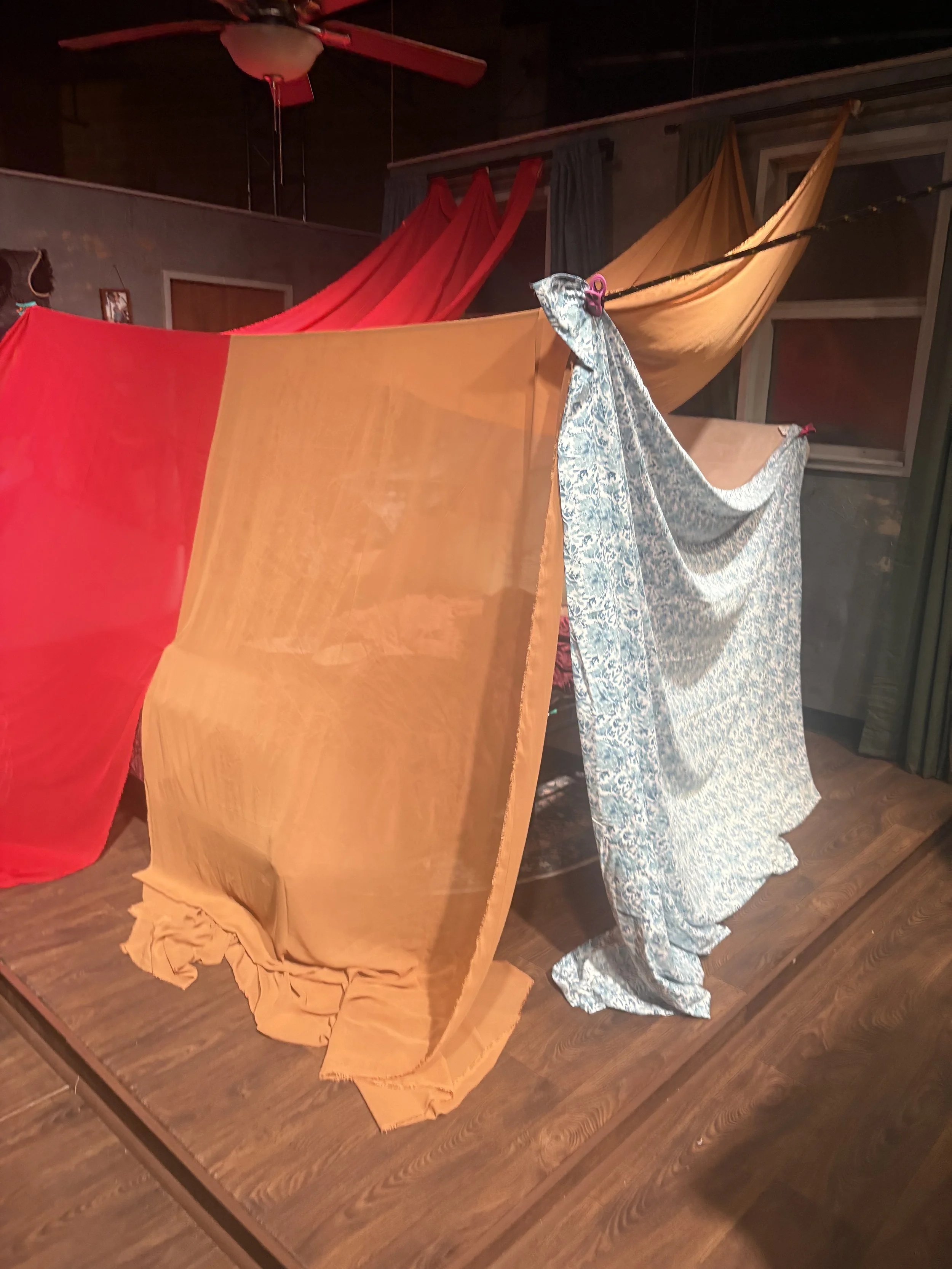 Trialing bedsheets as side walls for the fort in the play “Furlough’s Paradise” by A.K. Payne