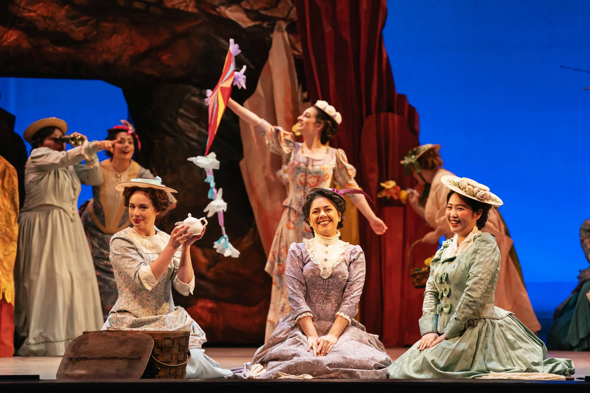 Women with a tea set basket and tissue paper kite in the opera “The Pirates of Penzance”