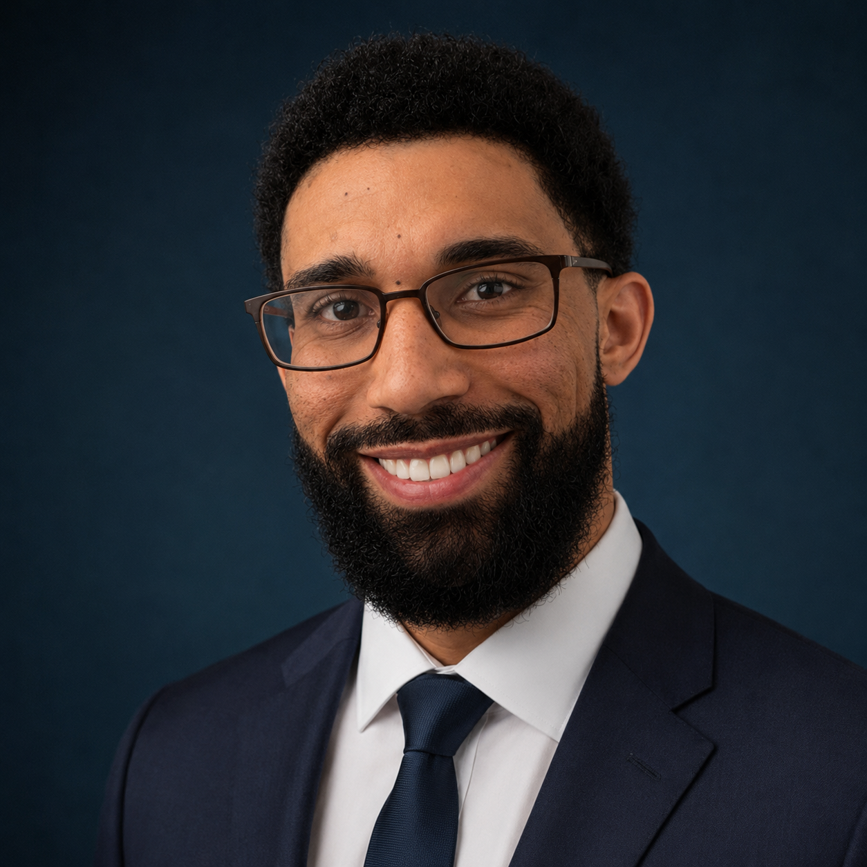 Derek White, attorney and founder of Derek J. White Law, LLC, wearing a navy suit and tie