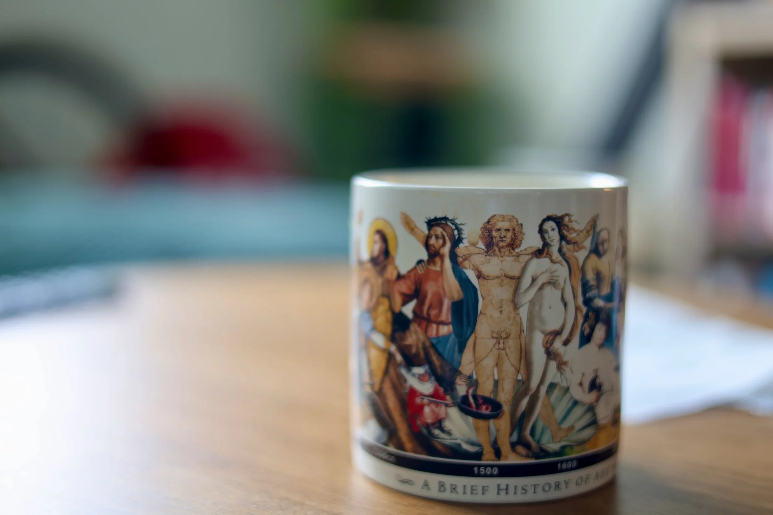 A coffee mug with images of historical figures from American history, featuring detailed illustrations and text.