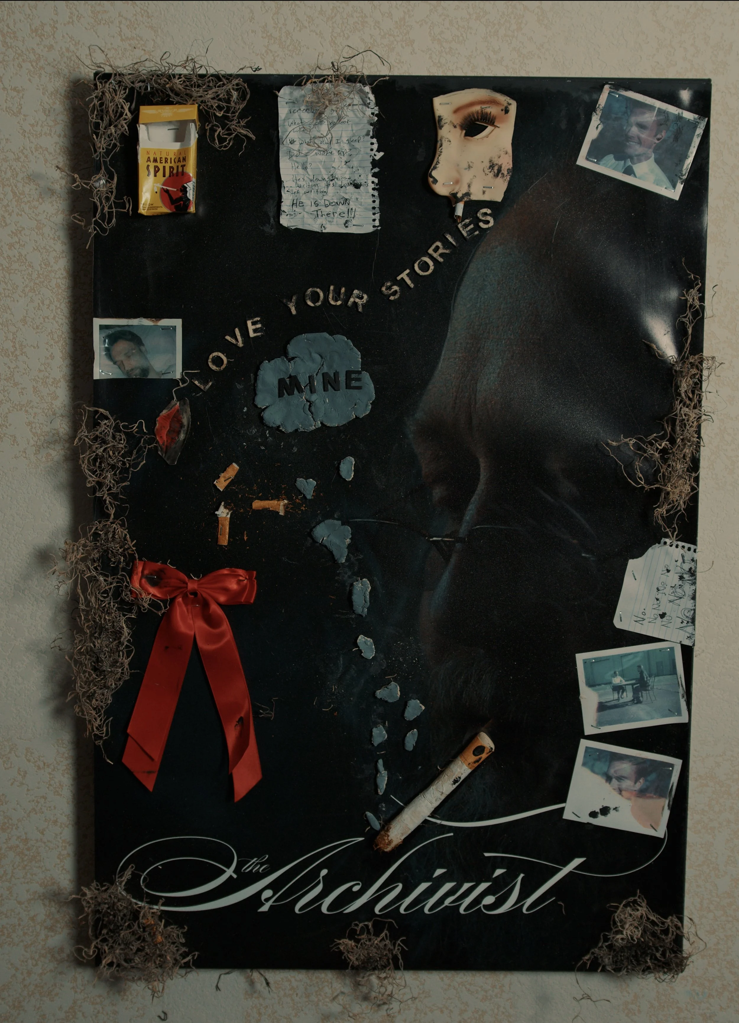 A memorial board with photographs, notes, and keepsakes, including a red ribbon, a pack of American Spirit cigarettes, a cigarette butt, and a drawing of an eye. The board has the phrase 'Love your stories' and the word 'Mine' on a cloud shape.