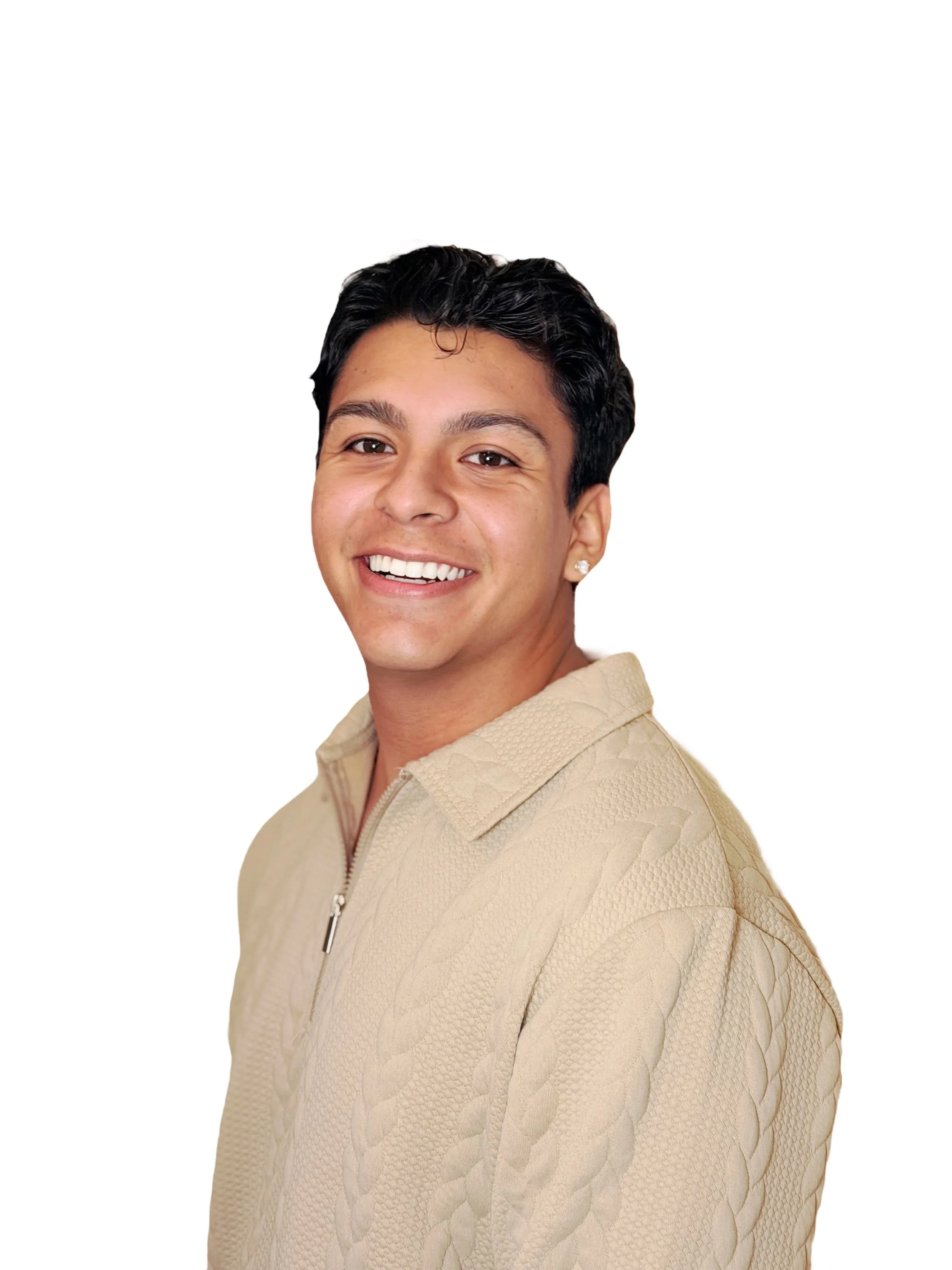Portrait of a young man with short black hair, smiling, wearing a beige textured zip-up jacket, standing against a white background.